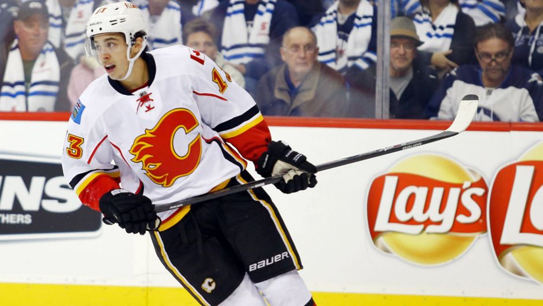 Oct 19, 2014; Winnipeg, Manitoba, CAN; Calgary Flames forward Johnny Gaudreau (13) during the third period against the Winnipeg Jets at MTS Centre. Calgary wins 4-1. Mandatory Credit: Bruce Fedyck-USA TODAY Sports