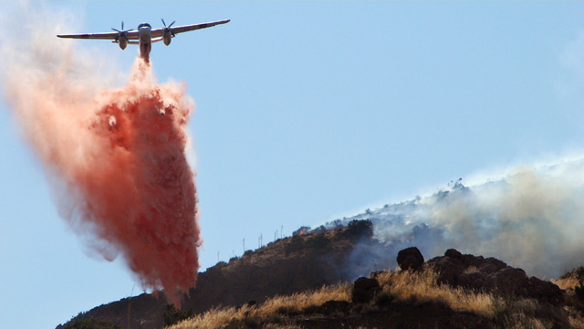 Sept. 5: An air tanker drops retardant next to a flank of a wildfire in Agua Dulce, Calif.