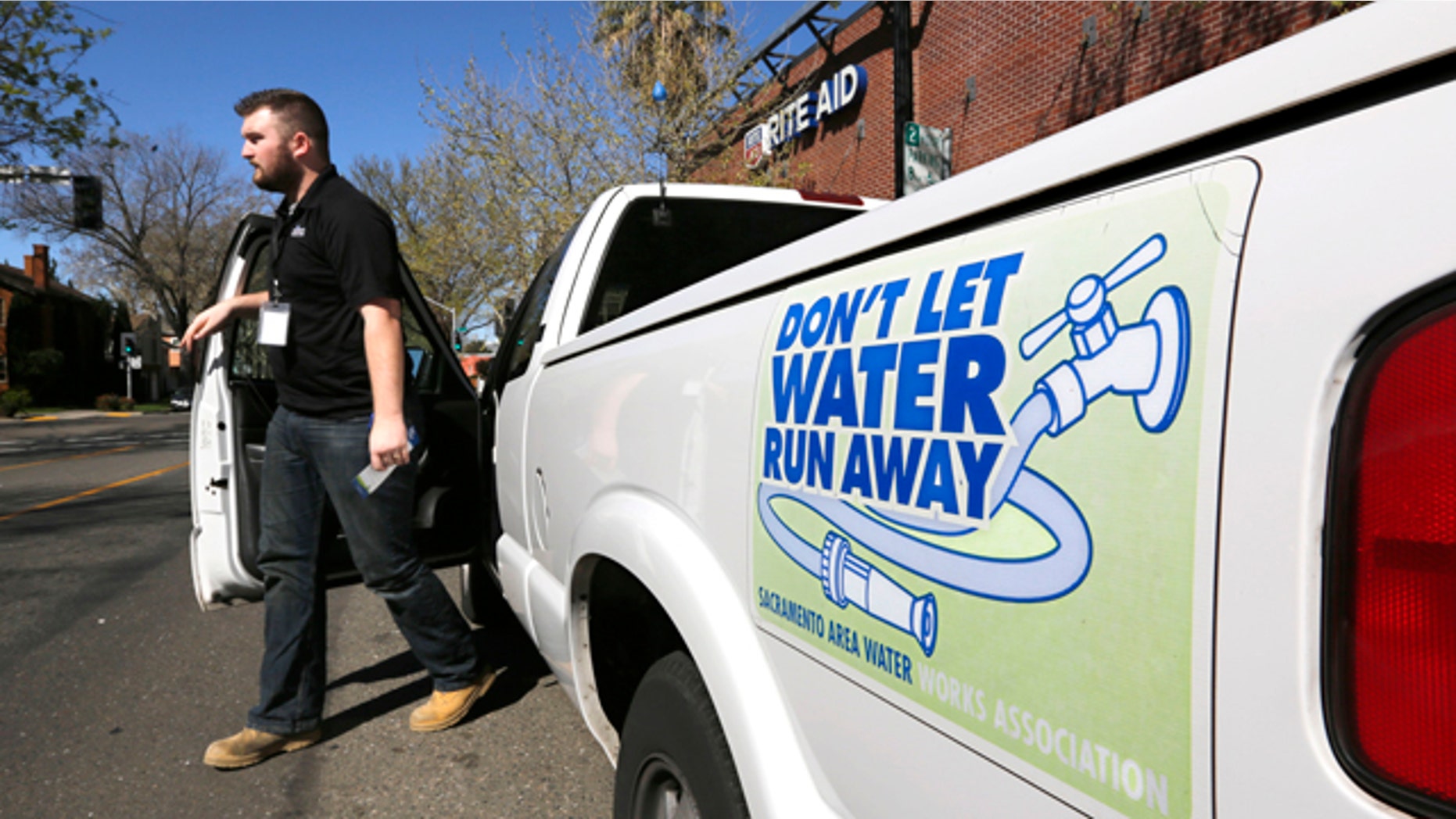 March 11, 2014: Steve Upton, an inspector for the water conservation unit for the Sacramento Utilities department, climbs out of his truck to make an inspection of an alleged water waste while making his rounds in Sacramento, Calif. At least 45 water agencies throughout California have imposed mandatory restrictions on water use as their supplies run dangerously low. (AP Photo/Rich Pedroncelli)