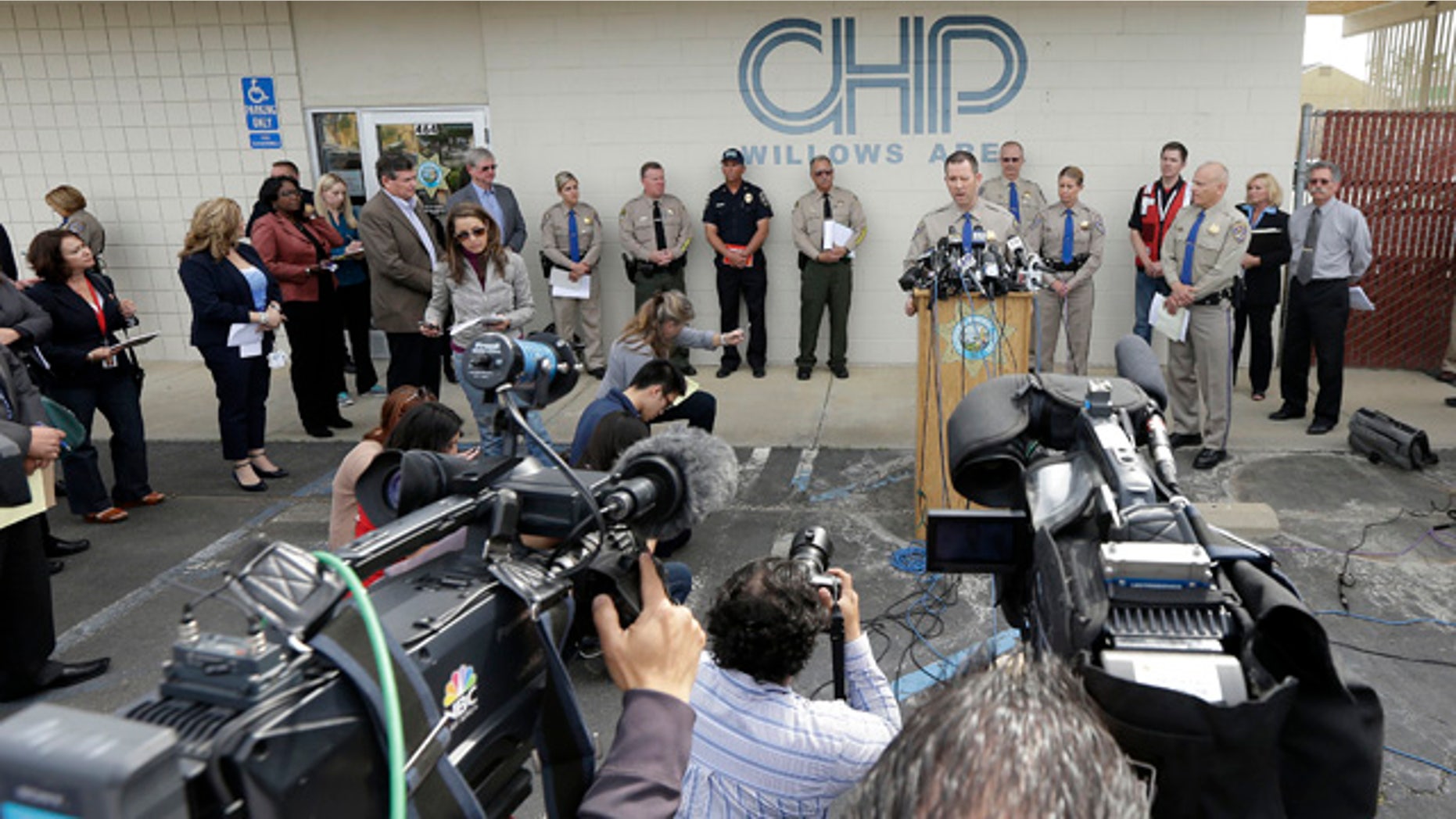 April 11, 2014: California Highway Patrol Multidisciplinary Accident Investigation Team Lt. Scott Fredrick, center right, speaks at a news conference in Willows, Calif. At least ten people were killed and dozens injured in the fiery crash between a FedEx truck and a bus carrying high school students on a visit to a Northern California College. (AP Photo/Jeff Chiu)