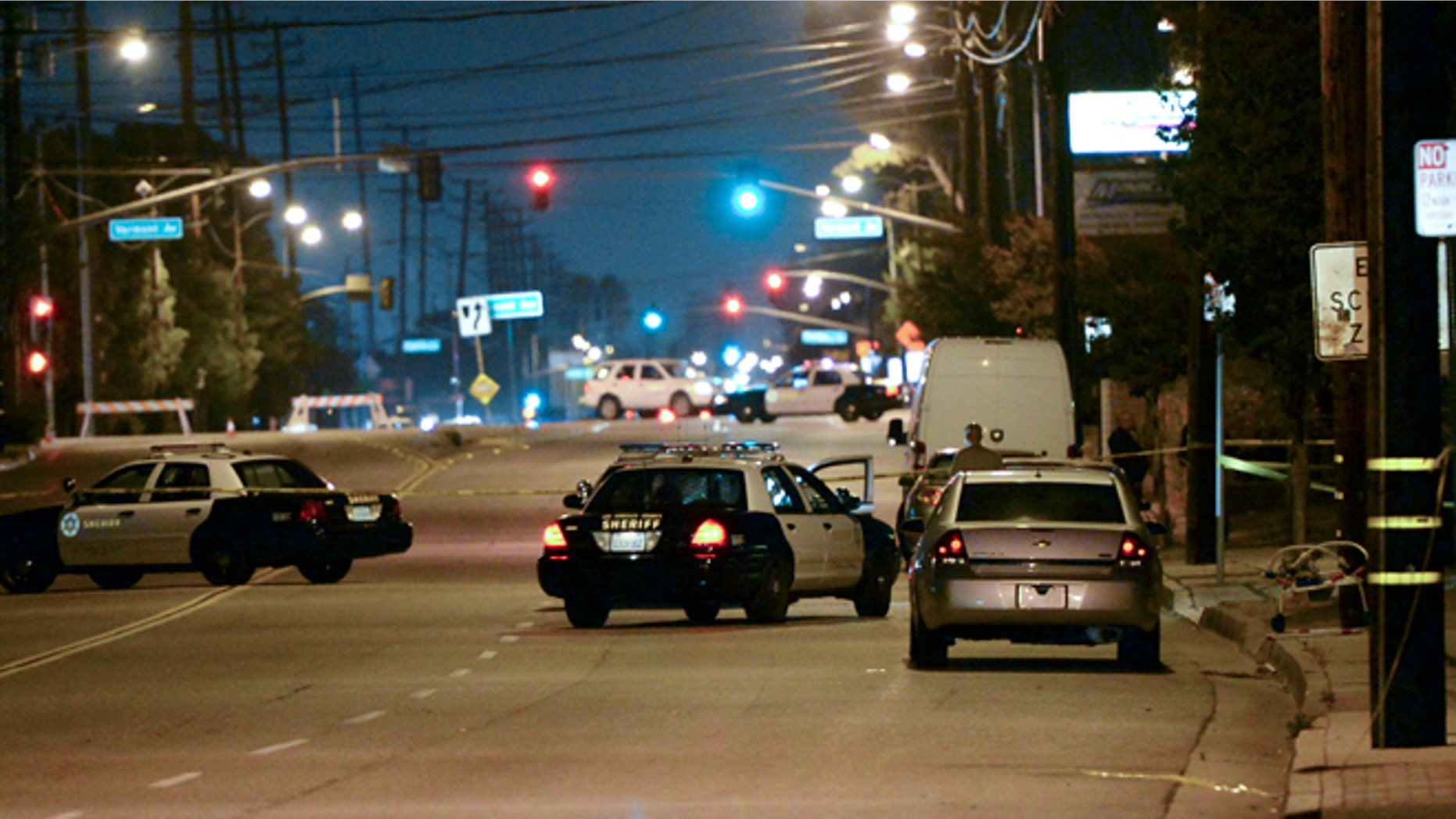 Los Angeles County sheriff's deputies block off the scene of a triple homicide that occurred in the unincorporated area of Los Angeles, Calif., Tuesday, May 20, 2014. Carol Coronado, 30, was arrested on suspicion of murder, taken to a hospital for examination and then to a sheriff's station for booking. Authorities say she made no statement. (AP Photo/The Daily Breeze, Steve McCrank)
