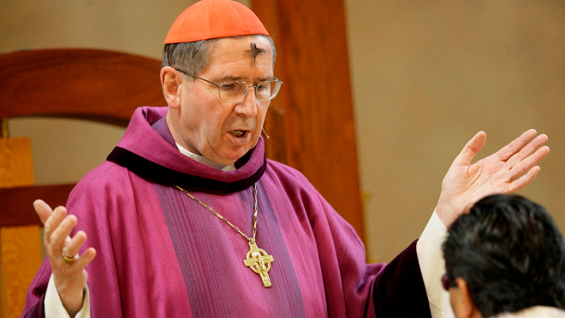 FILE - In this Feb. 6, 2008 file photo, Cardinal Roger Mahony officiates during Ash Wednesday services at the Cathedral of Our Lady of the Angels in Los Angeles. The Roman Catholic Archdiocese of Los Angeles will pay $13 million to settle 17 clergy abuse lawsuits, including 11 that involve a visiting Mexican priest who fled prosecution and remains a fugitive more than 25 years later, plaintiffs' attorneys said Tuesday Feb. 18, 2014. (AP Photo/Nick Ut, File)