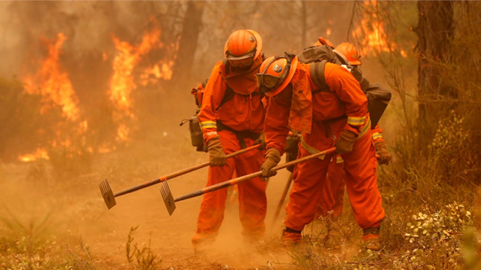 Sept. 12, 2015: A California Department of Corrections and Rehabilitation inmate work crew builds a containment line ahead of flames from a fire near Sheep Ranch, Calif. (AP Photo/Rich Pedroncelli, File)