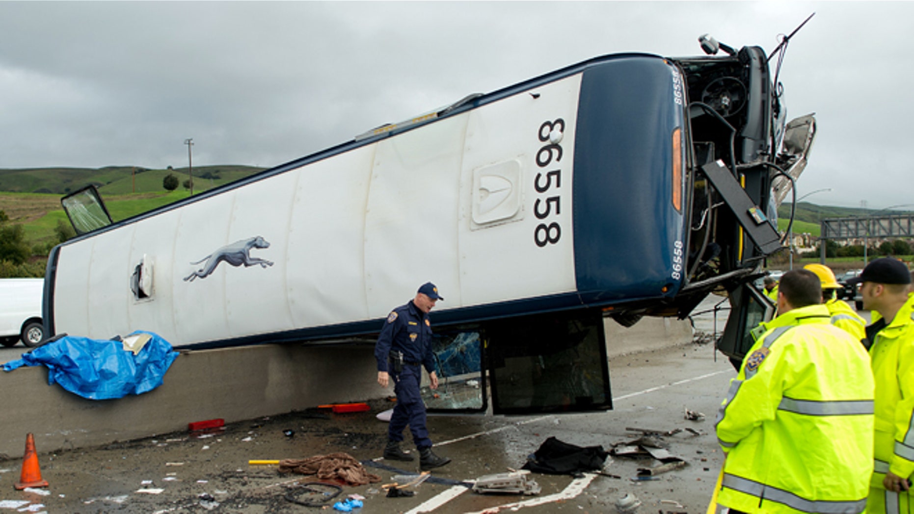 A California Highway Patrol investigator examines the scene of a fatal Greyhound bus crash, Tuesday, Jan. 19, 2016, in San Jose, Calif. The bus flipped on its side while traveling north on Highway 101, according to the San Jose Fire Department. (AP Photo/Noah Berger)