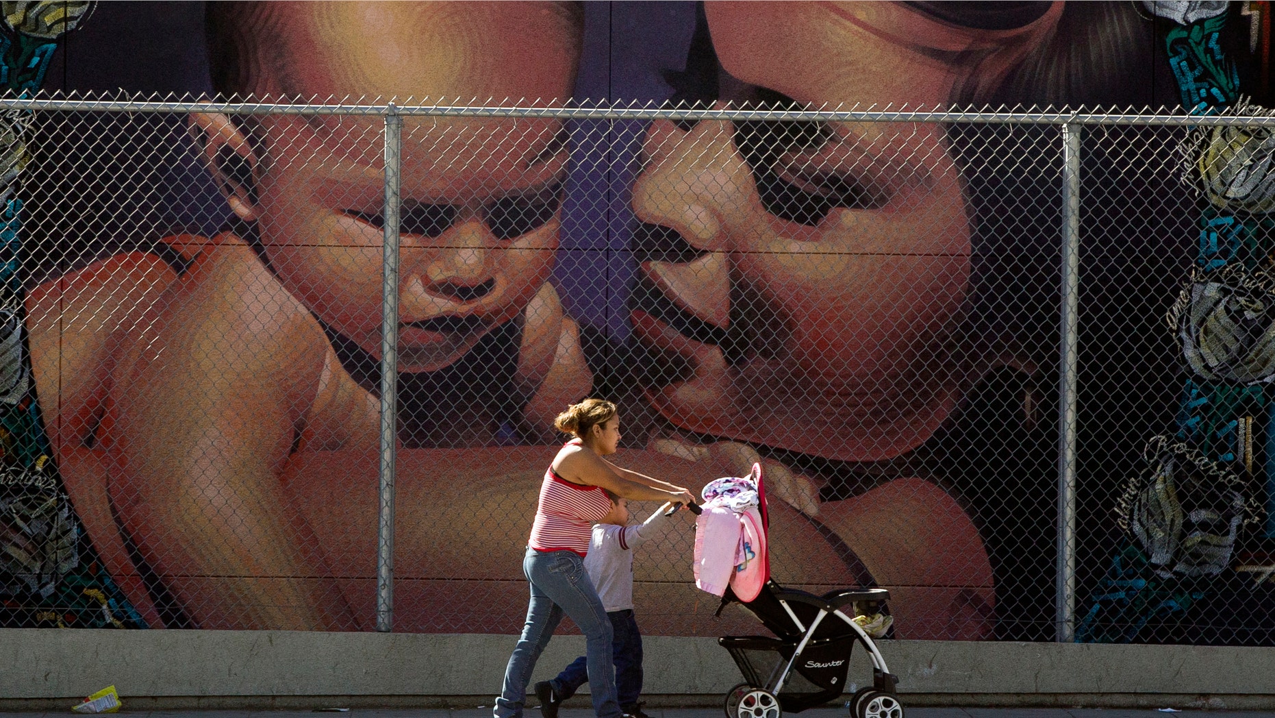 A mother walks with her children to the MacArthur Park Primary Center School in Los Angeles Thursday, Jan. 31, 2013. Within six months, California's Hispanic population will equal that of whites and soon after will surpass it, a milestone in the country's shifting demographics. Population projections to be released Thursday by the state Department of Finance show that Hispanics will become the dominant ethnic group in California for the first time since it gained statehood during the Gold Rush era. (AP Photo/Damian Dovarganes)