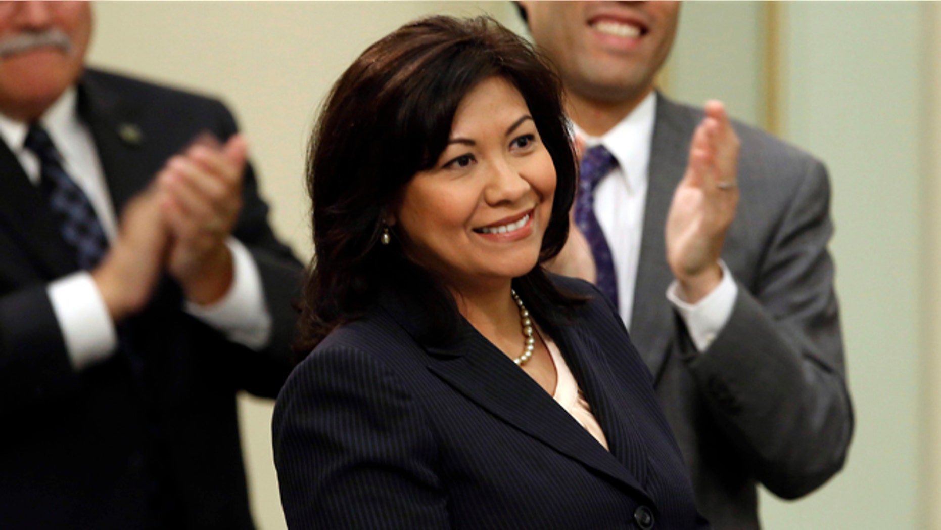 FILE -- In this May 16, 2013 file photo, Assemblywoman Norma Torres, D-Pomona, receives applause from members of the Assembly, including Assemblymen Jose Medina, D-Riverside, left, and Richard Pan, D-Sacramento, after winning the 32nd District Senate seat in a special election. Torres was 5 when she came to the United States from Guatemala. She became an American citizen in 1992. Now after serving in both houses of the state legislature, Torres is the heavy favorite to win a Congressional seat in November.(AP Photo/Rich Pedroncelli,file).