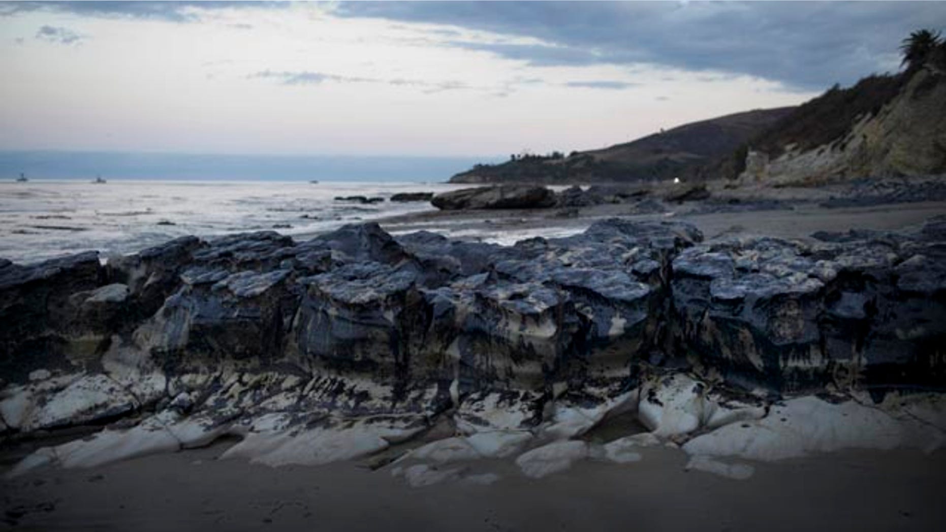 May 21, 2015: Rocks are covered with oil on the beach at Refugio State Beach, north of Goleta, Calif. (AP Photo/Jae C. Hong)
