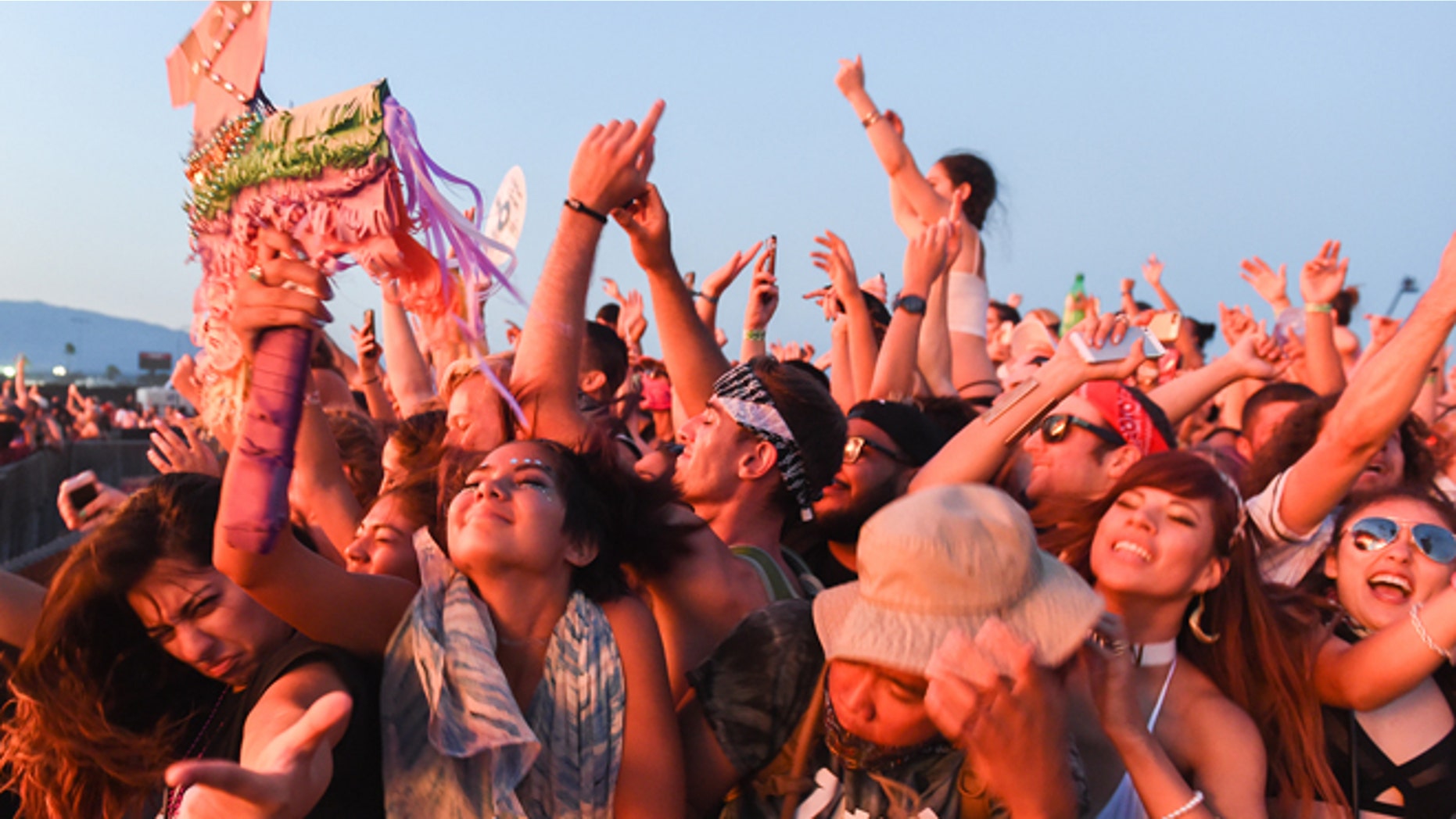 In this Sunday, July 31, 2016, photo, people attend the HARD Summer Music Festival at the Auto Club Speedway in Fontana, Calif. Authorities say multiple people died after attending the weekend rave. (John Valenzuela/The Sun via AP)