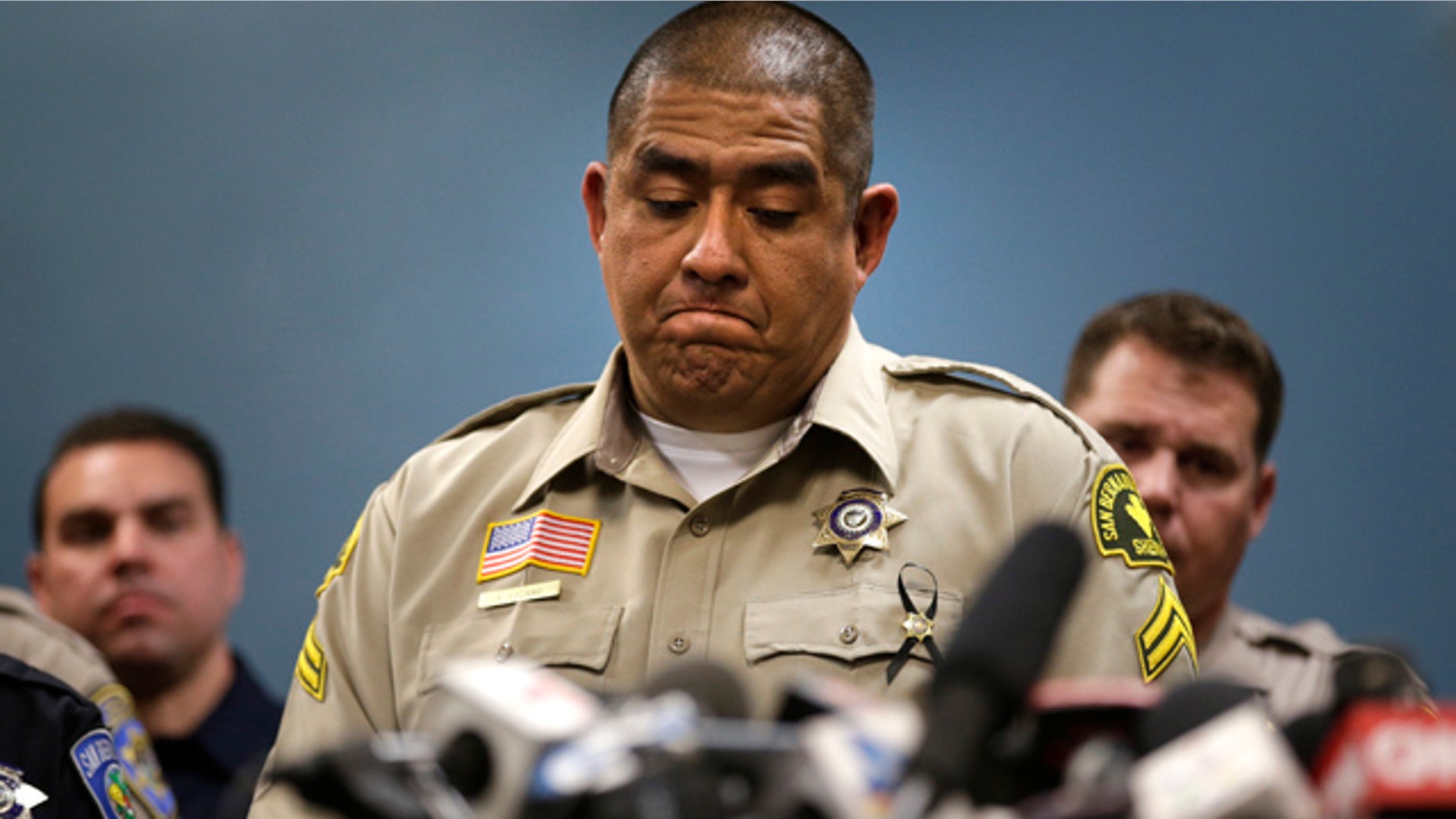 Dec. 8, 2015: San Bernardino County (Calif.) Sheriff's detective Jorge Lozano, center, pauses while answering questions during a news conference with the first responders on the scene of last week's fatal shooting at a social services center. (AP Photo/Jae C. Hong)
