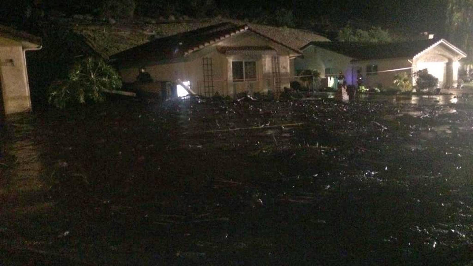 This image provided by the Ventura County Fire Department shows a home on San Como Lane in Camarillo Calif., inundated by mud and debris from a hillside early Saturday Nov. 1, 2014. Fire Capt. Mike Lindbery of the Ventura County Fire Department says residents from about 11 homes were evacuated early Saturday in the neighborhood of Camarillo. (AP Photo/Ventura County Fire Department, Capt. Mike Lindbery)
