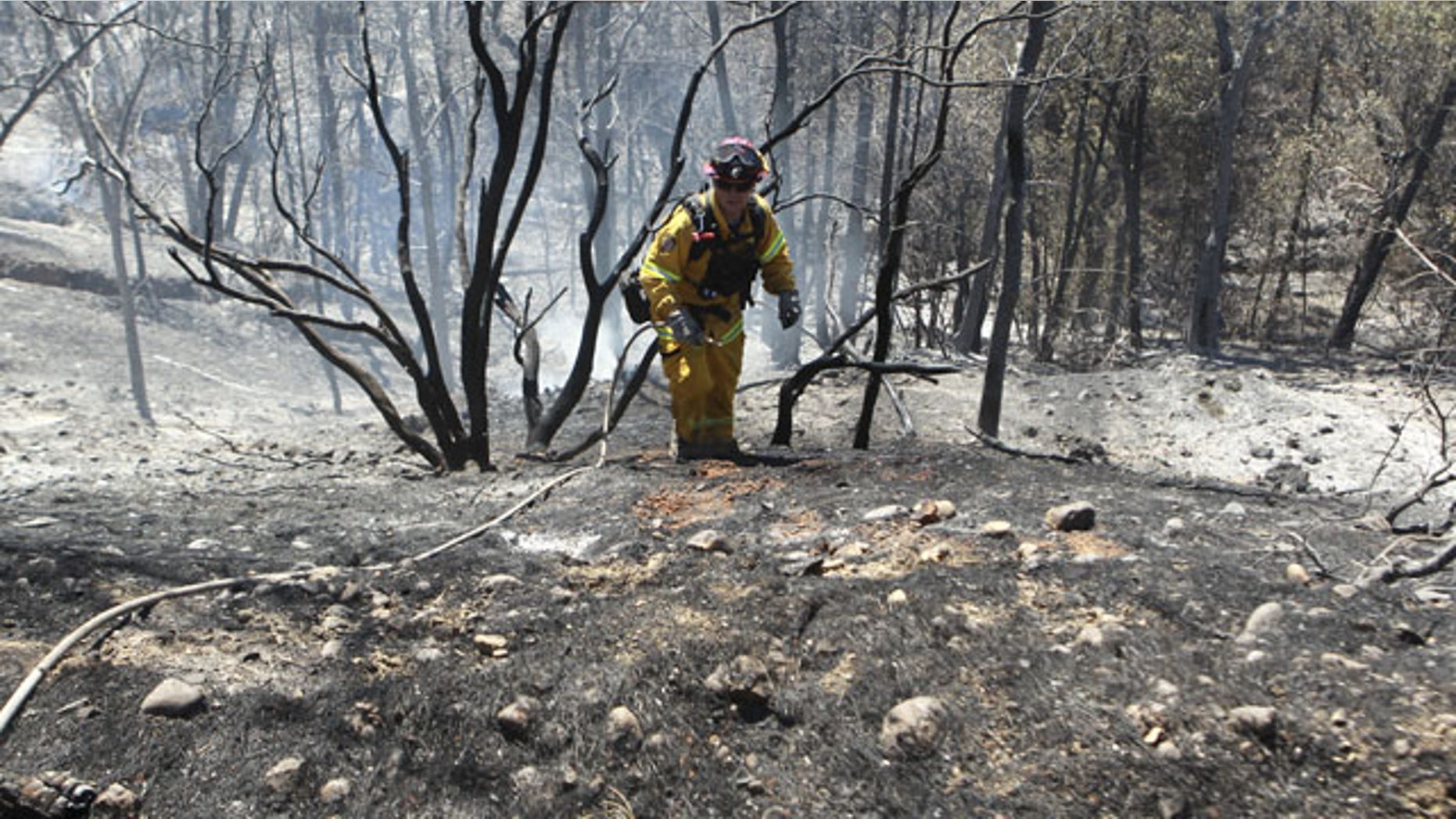 September 10, 2013: Colusa, Calif., Fire Captain Brad Long climbs up a steep incline after putting out hotspots off Clear Creek Road. He was part of the mop-up effort after the Clover Fire burned more than 7,000 acres in the Happy Valley area of Shasta County. (AP Photo)
