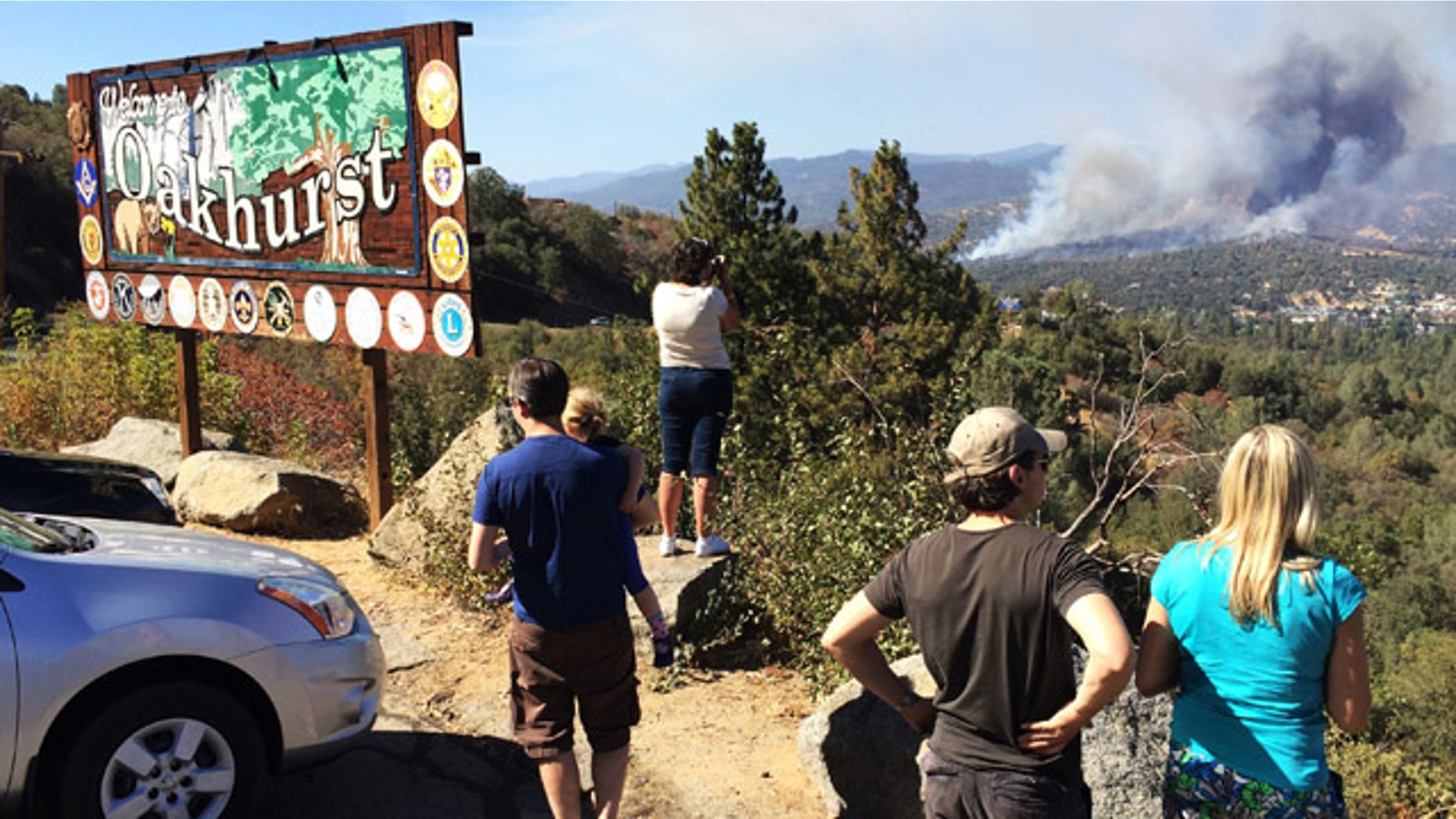 August 18, 2014: People watch a fire burning from the Highway 41 overlook on the way north into Oakhurst, Calif. The fire is burning north of the community. (AP Photo/The Fresno Bee, Eric Paul Zamora)