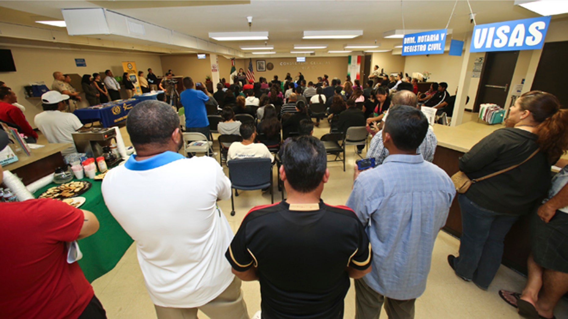 FILE - In this April 23, 2014, file photo, a crowd of approximately 80 immigrants fill a room as they listen to officials explain the process of getting a drivers license, during an information session at the Mexican Consulate, in San Diego. California is gearing up to start issuing driverâs licenses to immigrants in the country illegally in a bid to make the roads safer that could also give more than a million people access to state-issued identification. (AP Photo/Lenny Ignelzi,File)
