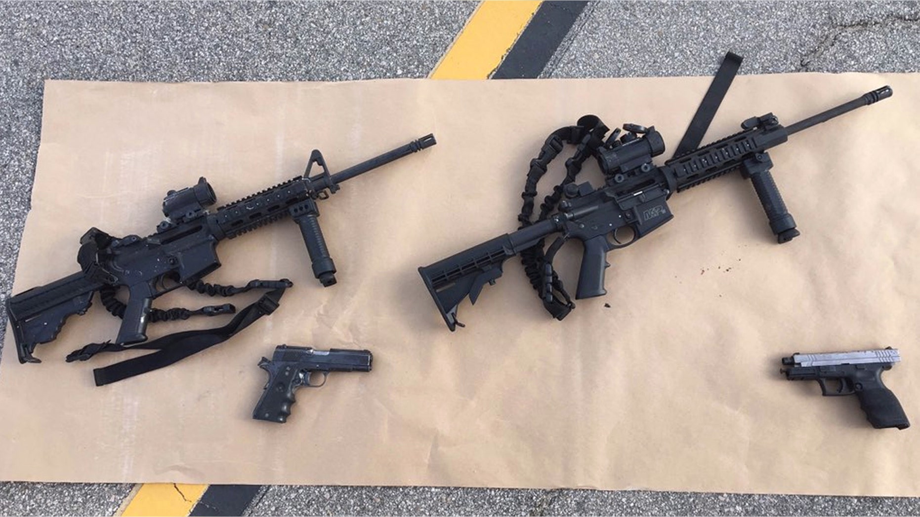 This photo provided by the San Bernardino County Sheriff's Department shows weapons carried by suspects at the scene of a shootout in San Bernardino, Calif. Multiple attackers opened fire on a banquet at a social services center for the disabled in San Bernardino on Wednesday, Dec. 2, 2015, killing multiple people and sending police on a manhunt for suspects. (San Bernardino County Sheriff's Department via AP)