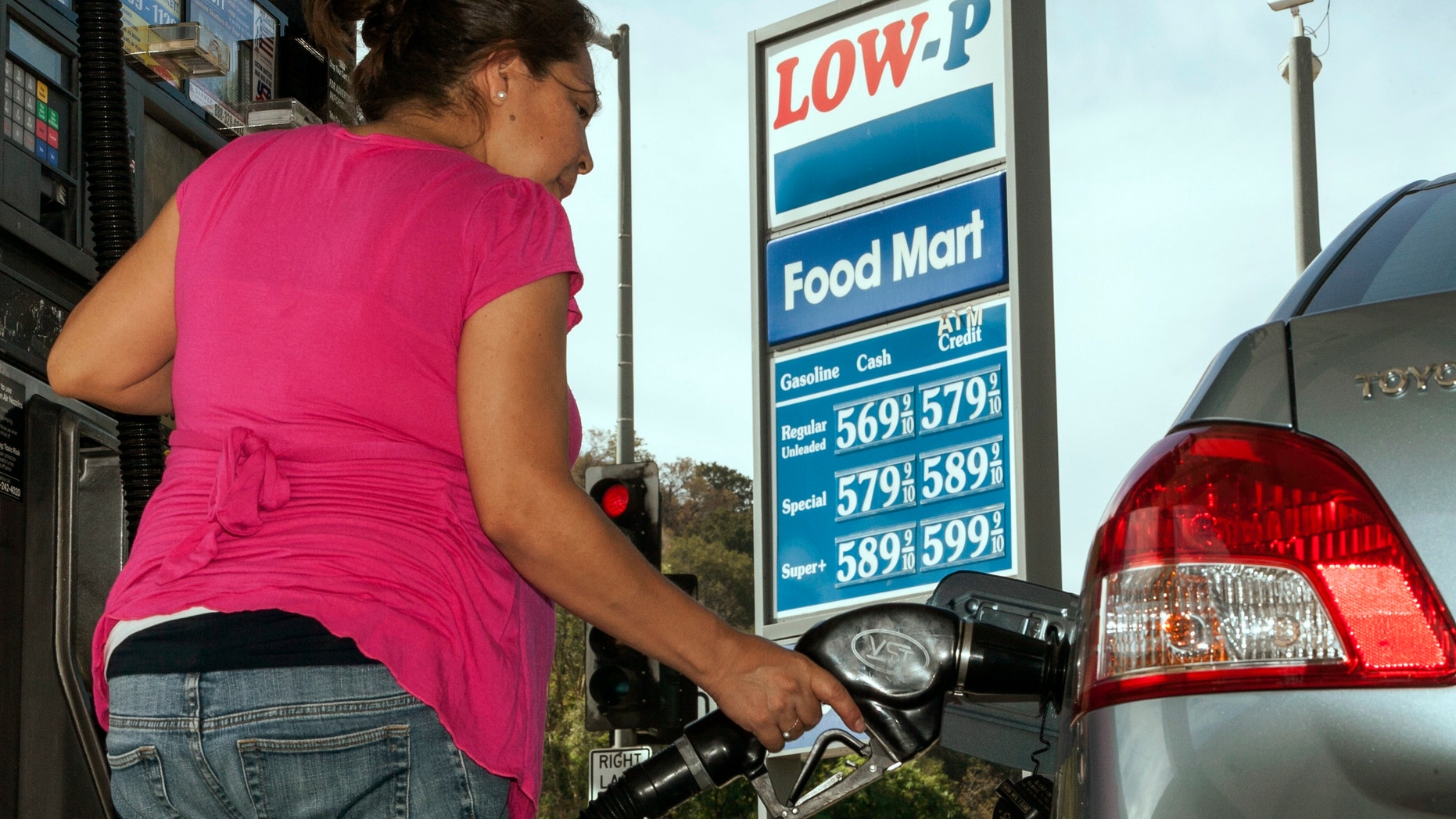 Oct. 5, 2012: Motorist Elisabeth Chavarria fills up only six dollars worth of gas to be able to drive home Friday, Oct. 5, 2012, at the Low-P, an independent gas station in Calabasas, Calif.