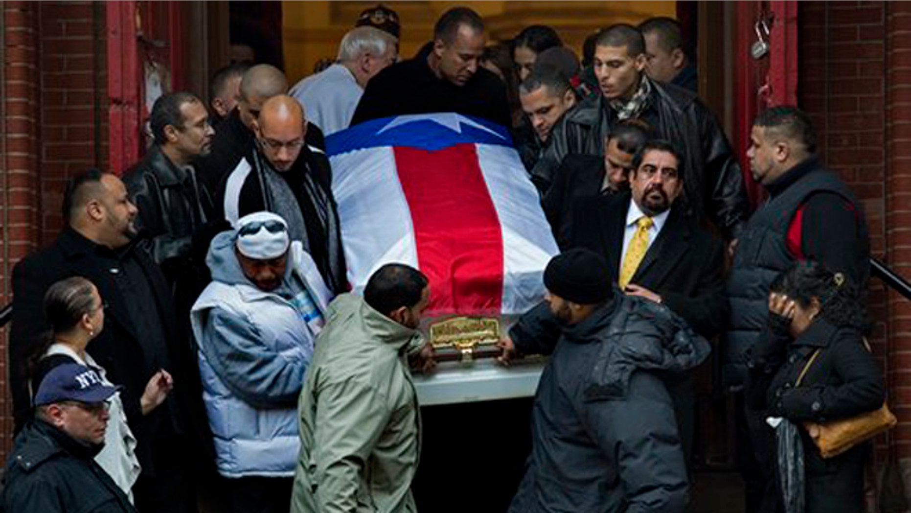 Hector "Macho" Camacho's casket is brought down the steps of St. Cecilia's Roman Catholic Church in New York after his funeral Saturday, Dec. 1, 2012. (AP Photo/Craig Ruttle)