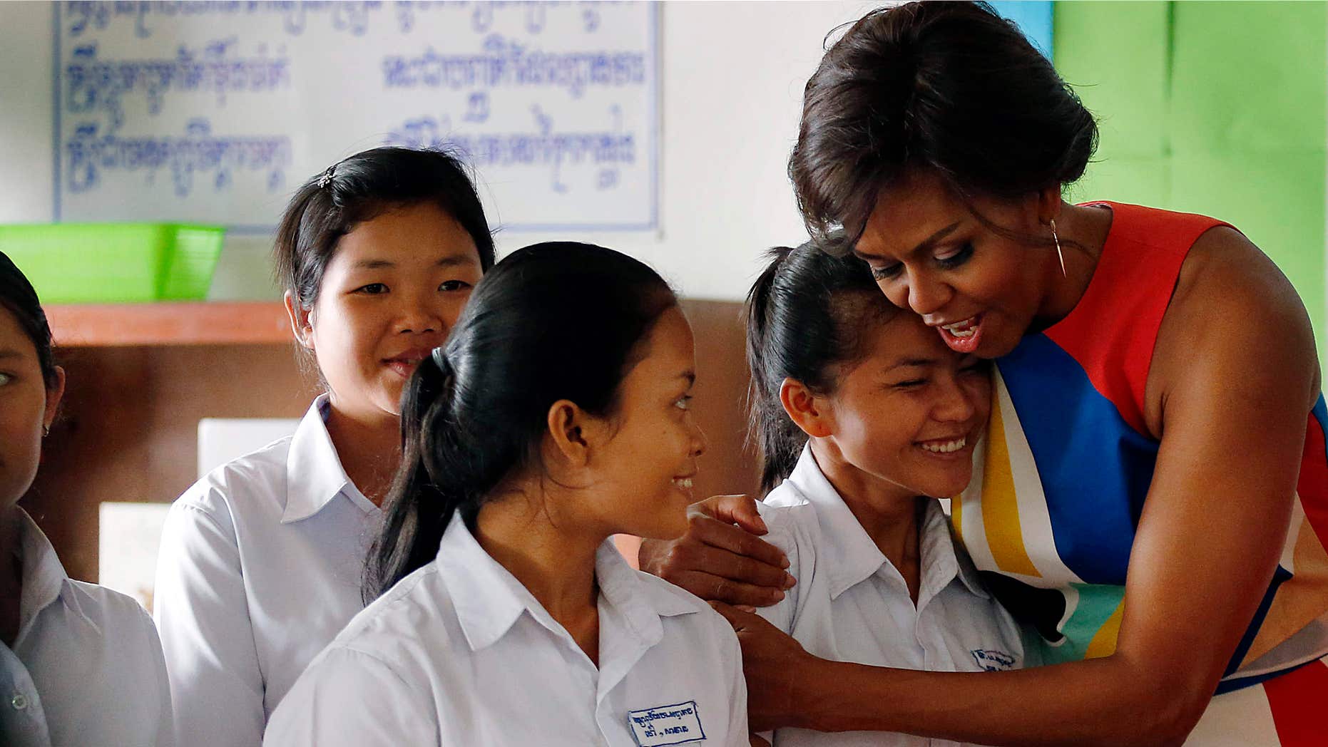 March 21, 2015: U.S. first lady Michelle Obama hugs Sohang Vean, a student at a local high school she was visiting.