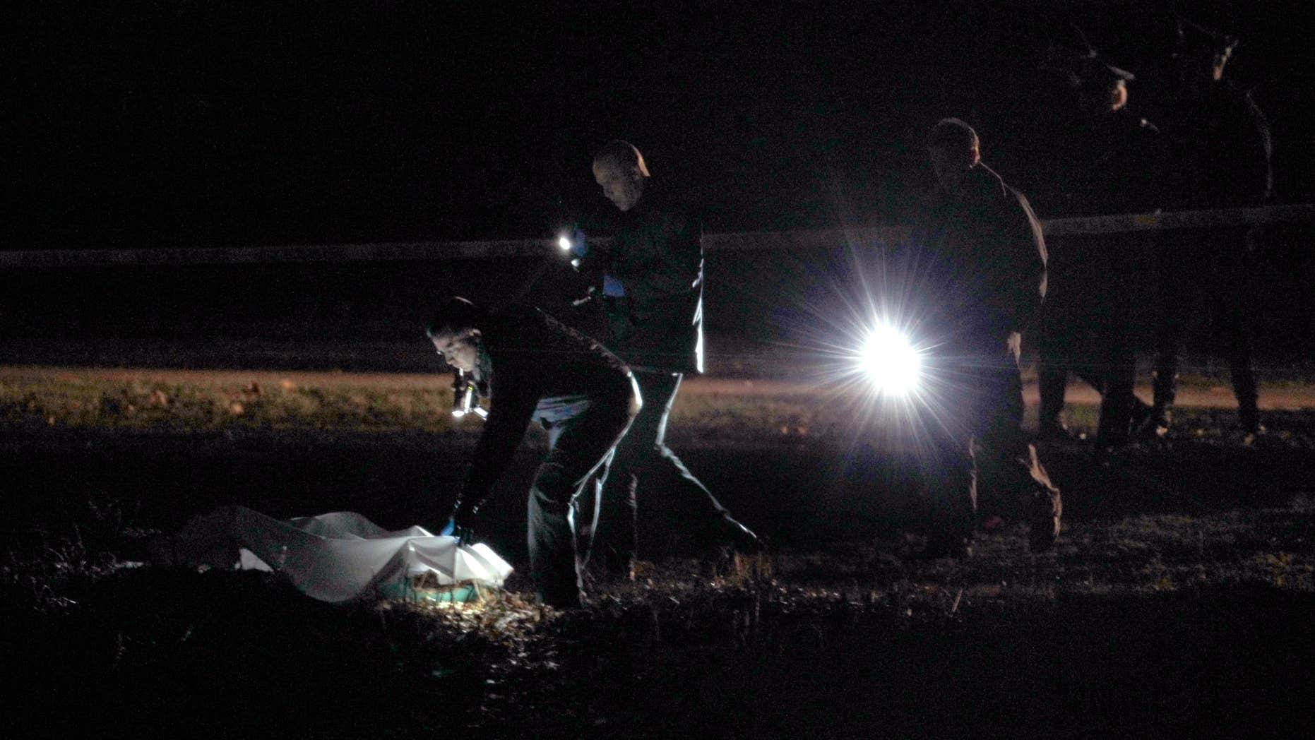 Dec. 9, 2011:nvestigators examine a crime scene along the Charles River in Boston.