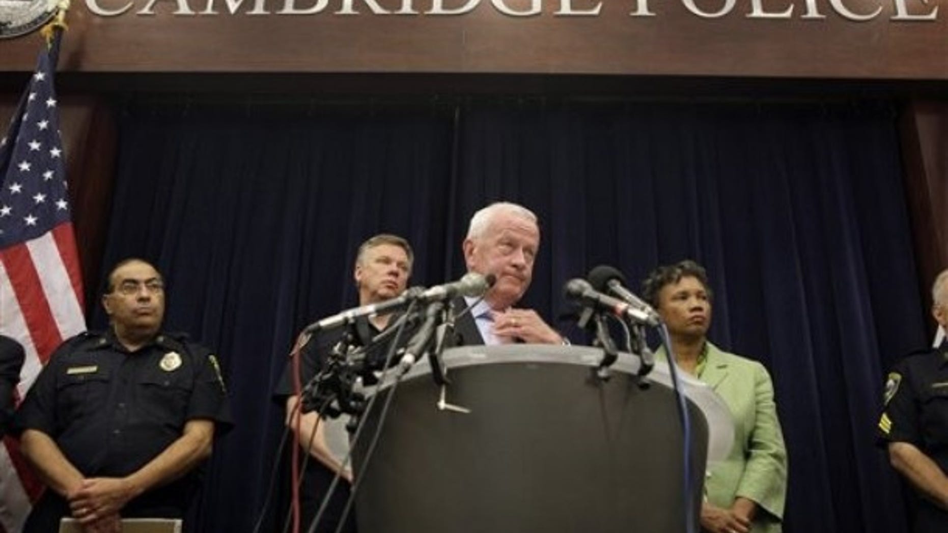 Cambridge City Manager Robert Healy answers reporter's questions concerning the arrest of Harvard Professor Henry Louis Gates Jr., as Mayor Denise Simmons, right, and Police Commissioner Robert Haas, near left, look on during a news conference at the Cambridge Police Department in Cambridge, Monday afternoon, July 27, 2009. Public Information Officer Frank Pasquarello stands at far left. (AP Photo/Stephan Savoia)