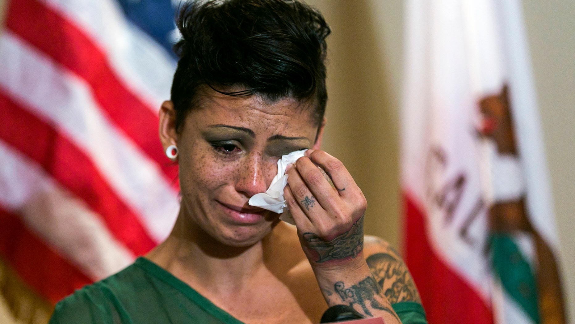 Cameron Bay, an adult film performer who became infected with HIV, cries as she speaks out about her treatment by the porn industry on Wednesday. (AP Photo/Damian Dovarganes)