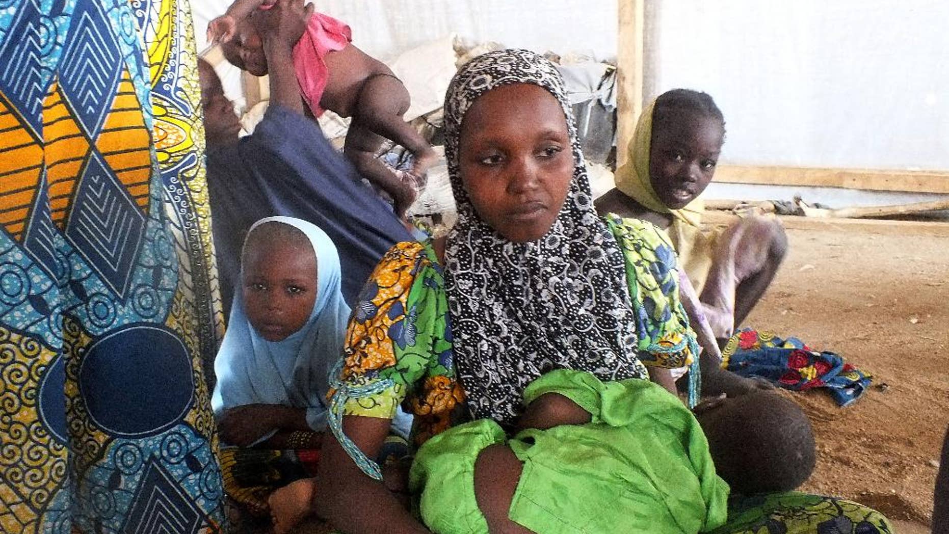 FILE -In this file photo taken on Wednesday, Feb. 25, 2015, a family of refugees that fled their homes due to violence from the Islamic extremist group Boko Haram sit inside a refugee camp in Minawao, Cameroon. With radical Islamic insurgents on its doorstep, Cameroon is trying to head off unrest at home by quelling any signs of the extremism that has roiled neighboring Nigeria. In recent months, Cameroon has arrested dozens of imams and their followers accused of promoting radical ideology and collaborating with Nigeria’s Boko Haram militants. (AP Photo/Edwin Kindzeka Moki)