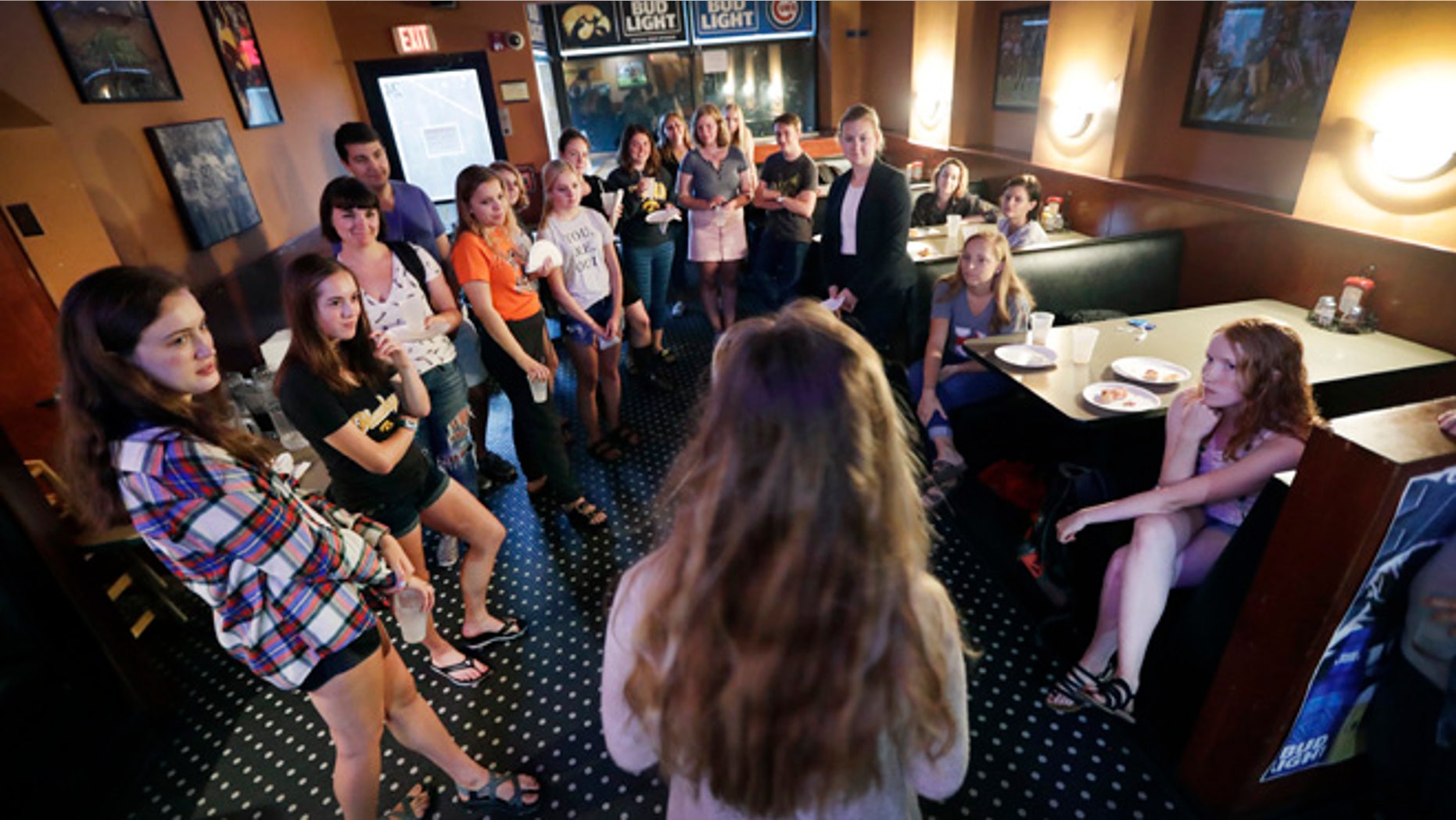 In this photo taken Sept. 7, 2016, University of Iowa students listen during a Hillary Clinton for President organizing event in Iowa City, Iowa. The Clinton campaign is working in about a dozen battleground states as their aggressive voter turnout apparatus kicks into high gear for the sprint to Election Day. In Iowa alone, 25,000 volunteers are helping send real-time data on voters back to the campaignââ¬â¢s Brooklyn headquarters, where dozens of analysts model the electorate .(AP Photo/Charlie Neibergall)