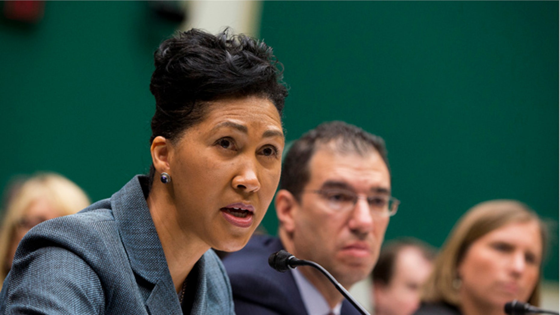 FILE: Oct. 24, 2013: Cheryl Campbell, Senior vice president of CGI Federal, left, testifies on Capitol Hill in Washington. D.C.