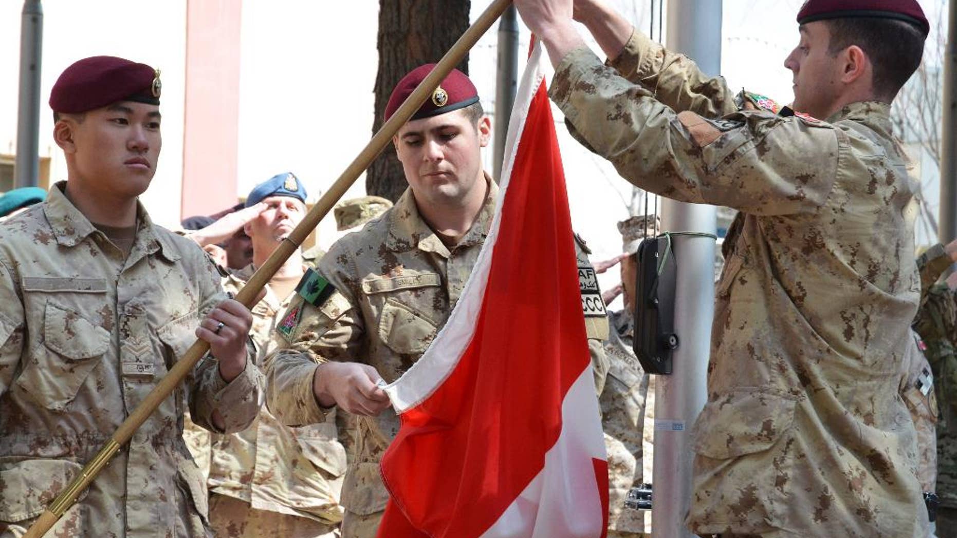 The army takes down the Canadian flag for the last time in Afghanistan bringing an end to 12 years of military involvement in a campaign, Wednesday March 12, 2014, in Kabul, Afghanistan. The war cost the lives of 158 soldiers, one diplomat, one journalist and two civilian contractors, according to The Canadian Press. (AP Photo/The Canadian Press, Murray Brewster)