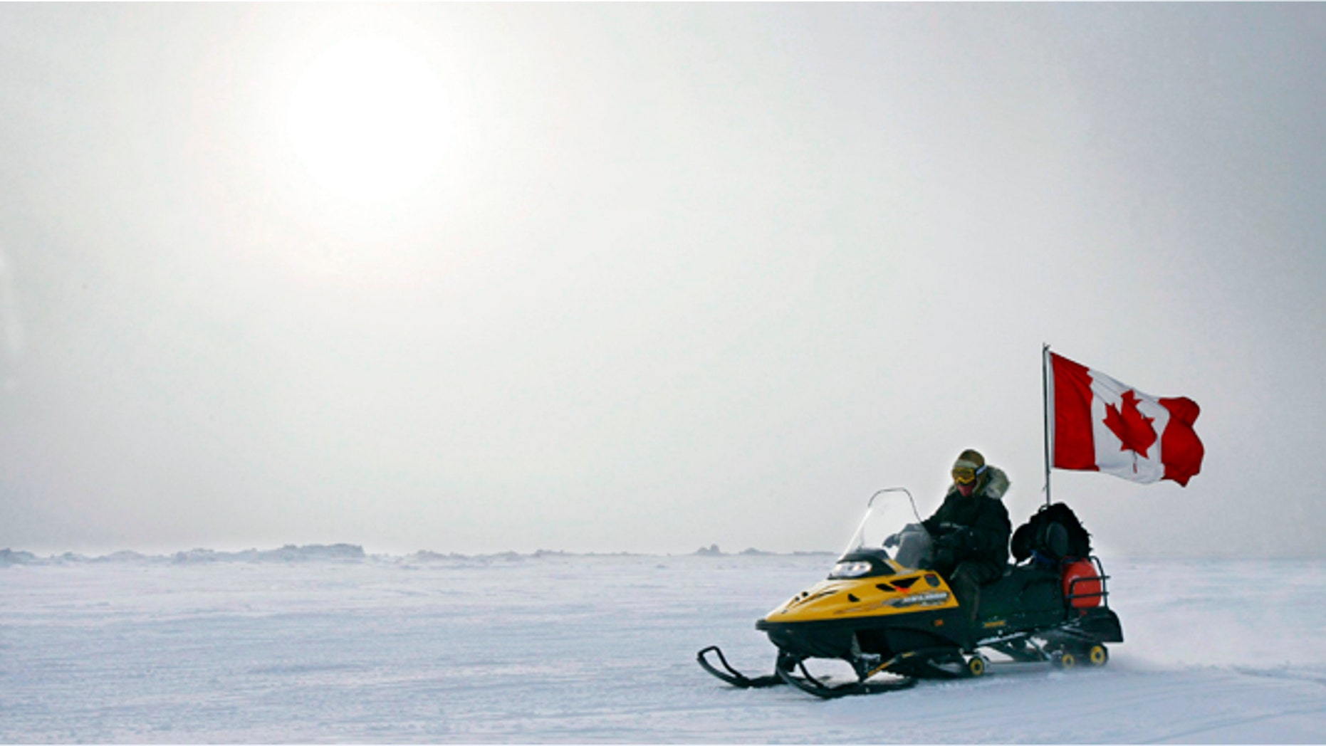 In this March 31, 2007 photo, Ranger Joe Amarualik, from Iqaluit, Nunavut, drives his snowmobile on the ice during a Canadian Ranger sovereignty patrol near Eureka, on Ellesmere Island, Nunavut. Canada plans to make a claim to the North Pole in an effort to assert its sovereignty in the resource-rich Arctic, the country's foreign affairs minister said Monday, Dec. 9, 2013.