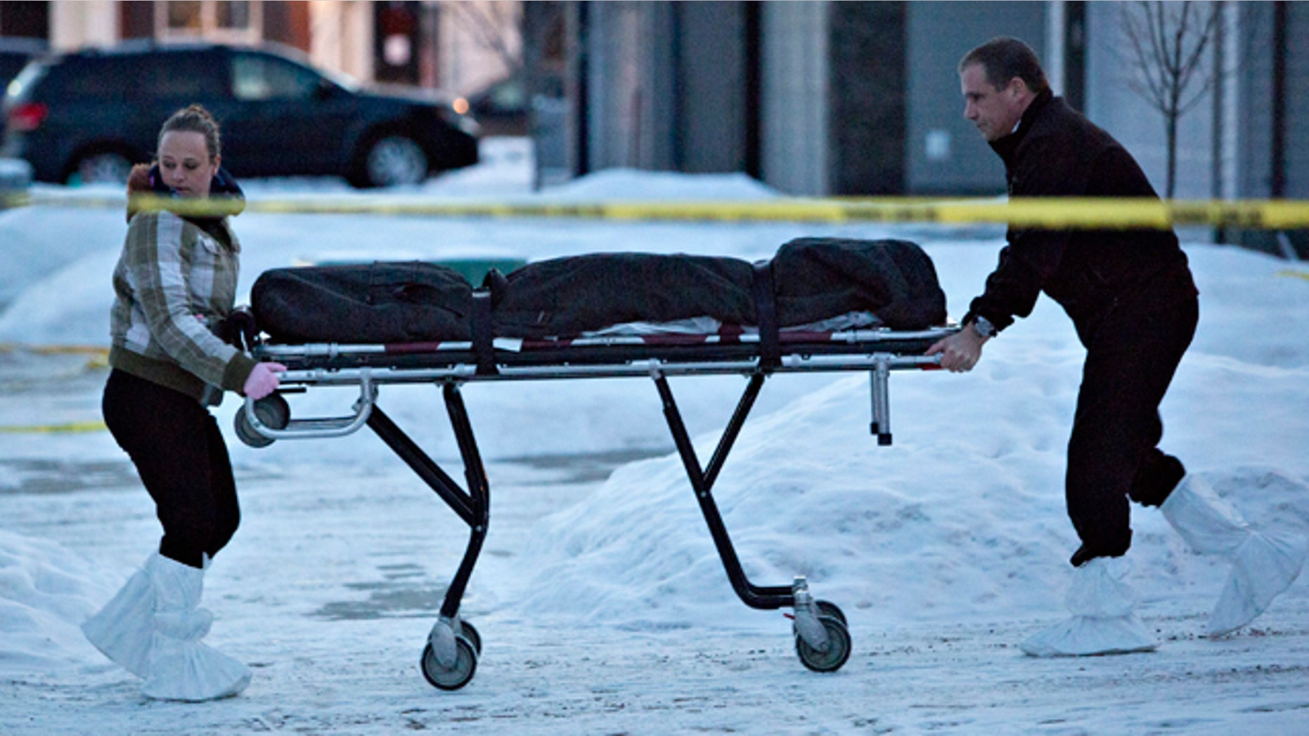 Dec. 30, 2014: The body of a victim is carried out of a north Edmonton home in Edmonton, Alberta, Canada. Nine people, including seven adults and two young children, were found dead at three separate crime scenes in what Edmonton's police chief on Tuesday called a 'senseless mass murder.' (AP Photo/The Canadian Press, Jason Franson)
