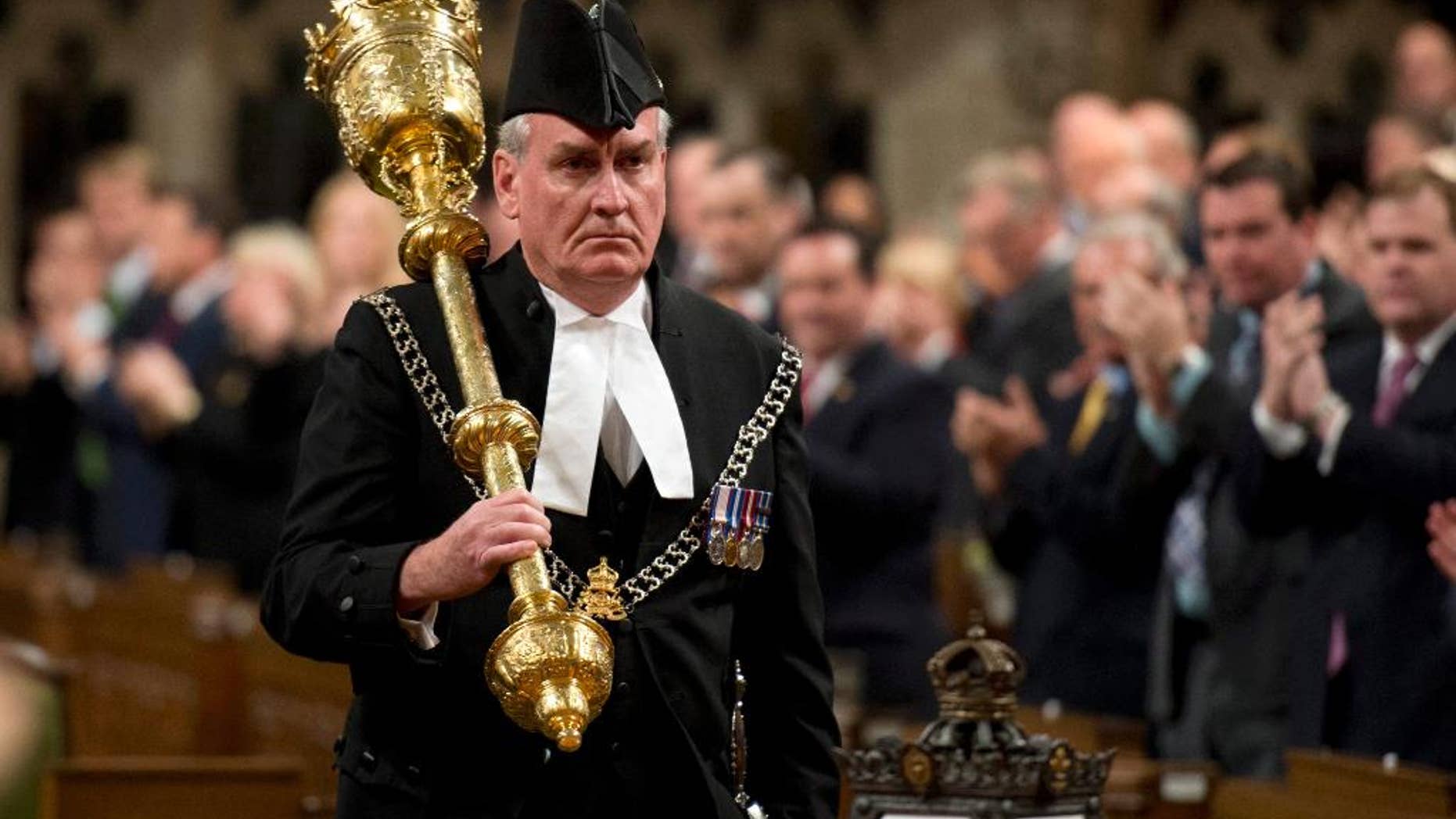 FILE - In a Thursday, Oct. 23, 2014 file photo, Sergeant-at-Arms Kevin Vickers receives a standing ovation as he enters the House of Commons in Ottawa. The Canadian Press reported Thursday, Jan. 8, 2015 that Vickers, hailed as a hero for killing the gunman who stormed Canada's parliament last year will be named ambassador to Ireland. (AP Photo/The Canadian Press, Adrian Wyld, File)