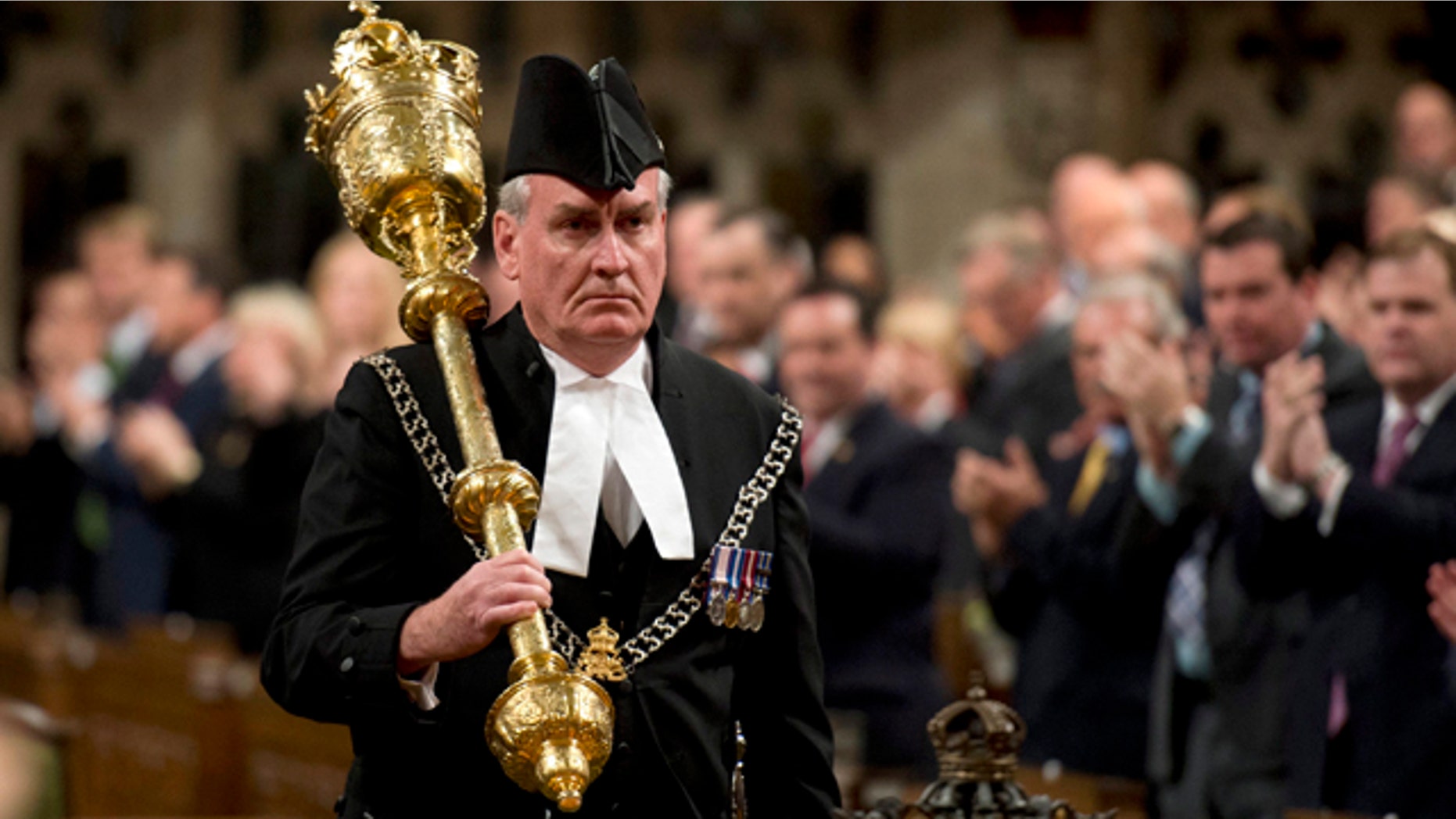 Oct. 23, 2014: Sergeant-at-Arms Kevin Vickers receives a standing ovation as he enters the House of Commons in Ottawa. (AP Photo/The Canadian Press, Adrian Wyld, File)
