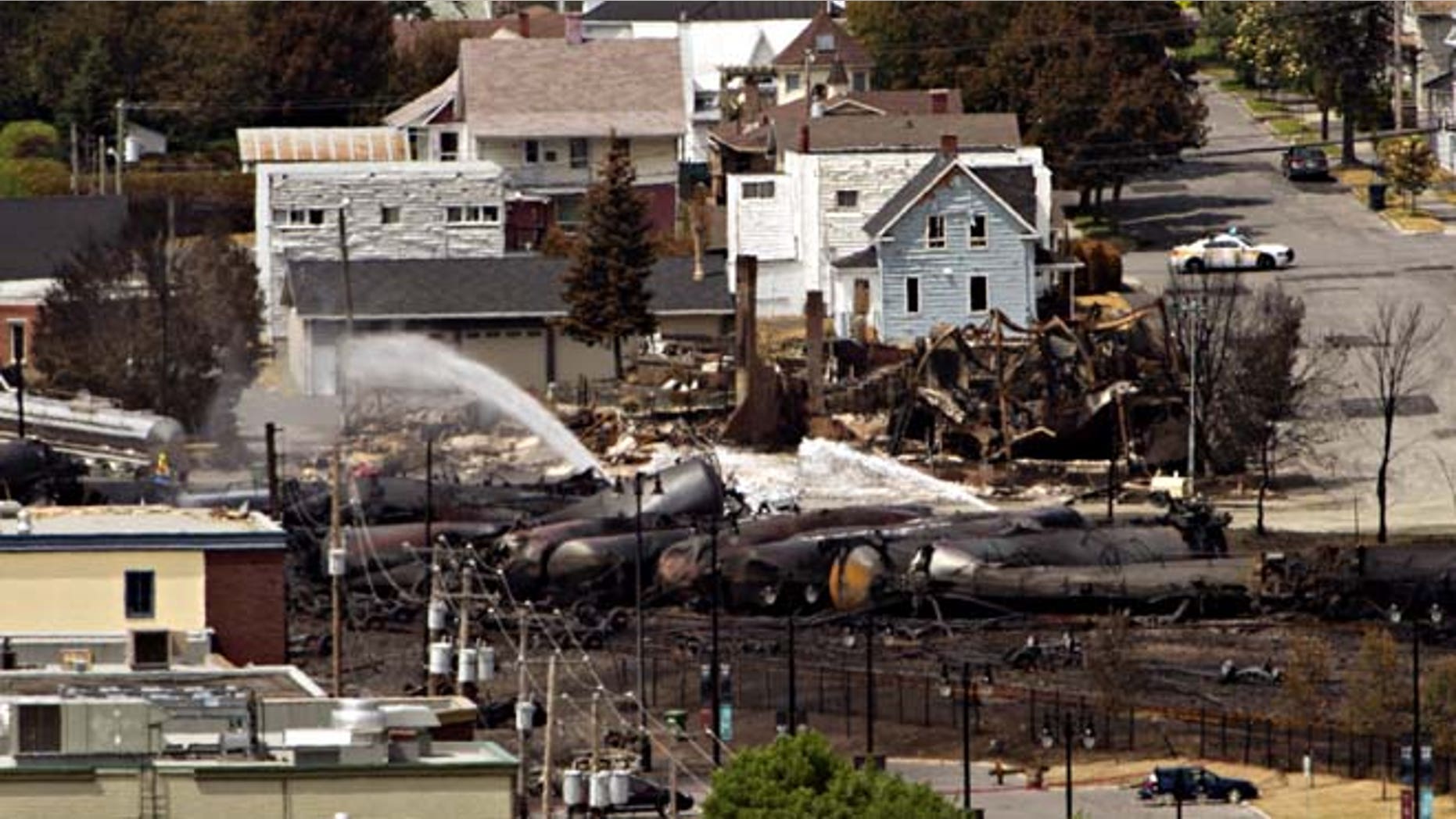 July 8, 2013: Wreckage is strewn through the downtown core in Lac-Megantic, Quebec after a train derailed, igniting tanker cars carrying crude oil early Saturday.