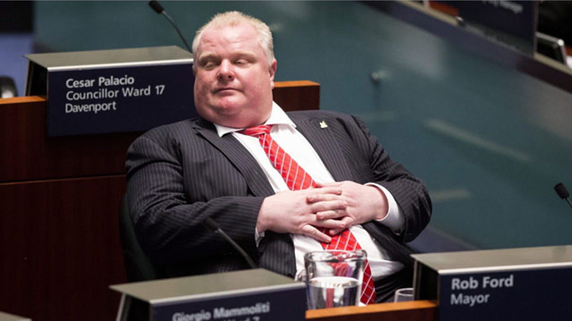 November 18, 2013: Toronto Mayor Rob Ford sits in the council chamber as Councillors look to pass motions to limit his powers. Ford called the effort a "coup d'etat" and challenged the council to call snap elections. (AP Photo/The Canadian Press, Chris Young)