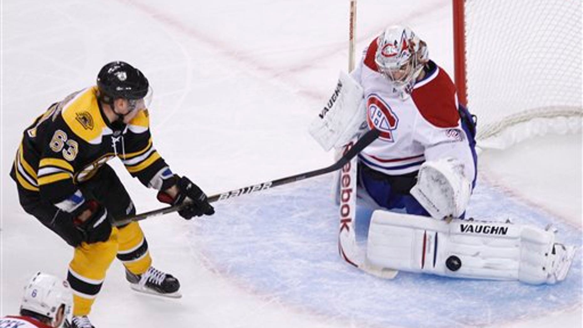 April 14: Boston Bruins center Brad Marchand, left, shoots as Montreal Canadiens goalie Carey Price makes the save in the first period of a first-round NHL hockey playoff game in Boston. (AP)