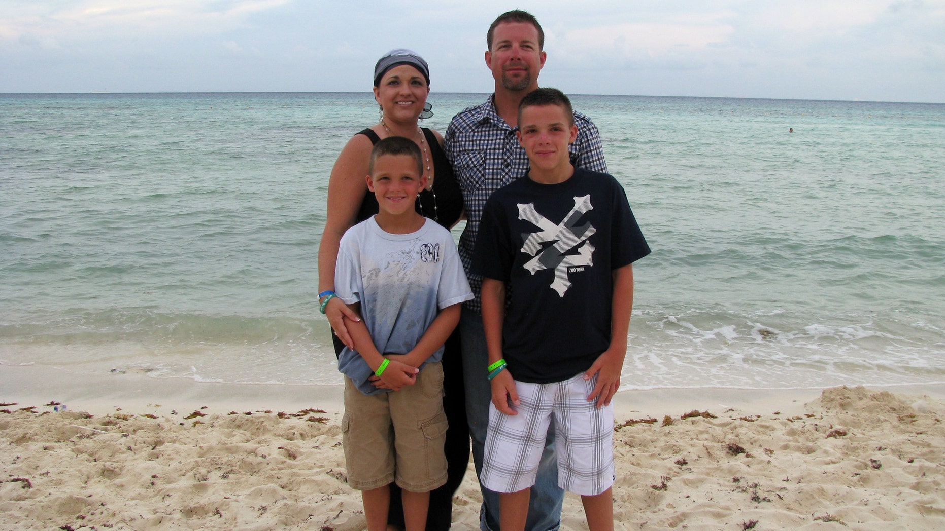 Arrica Wallace with her husband, Matthew, and sons Marccus and Mason in Mexico during a vacation. Since receiving immune therapy 22 months ago she has shown no sign of cancer. (AP Photo/Courtesy Arrica Wallace)