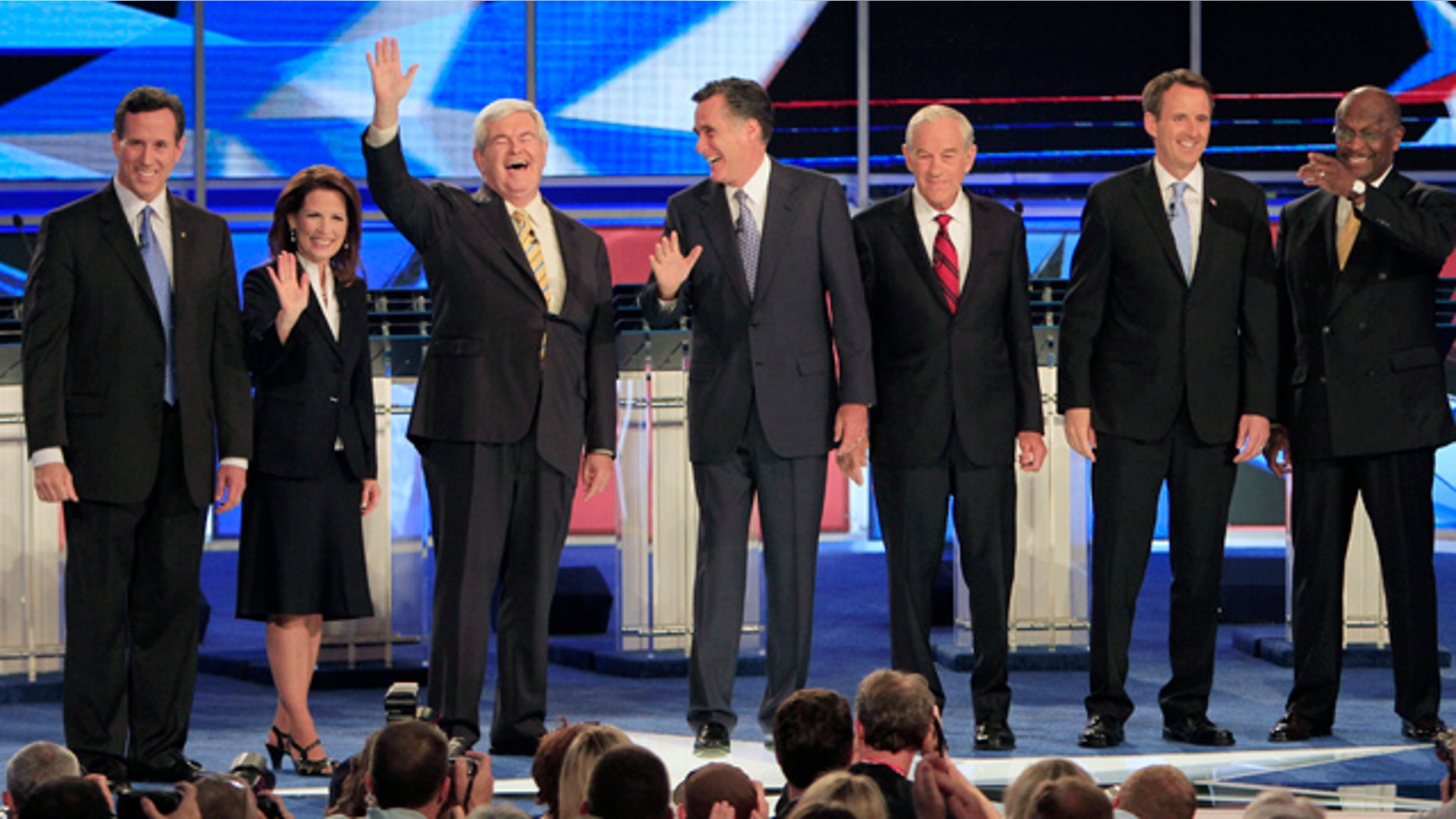 June 13, 2011: From left, former Pennsylvania Sen. Rick Santorum, Rep. Michele Bachmann, R-Minn., former House Speaker Newt Gingrich, former Massachusetts Gov. Mitt Romney, Rep. Ron Paul, R-Texas, former Minnesota Gov. Tim Pawlenty and businessman Herman Cain stand on stage before a Republican presidential debate in New Hampshire.
