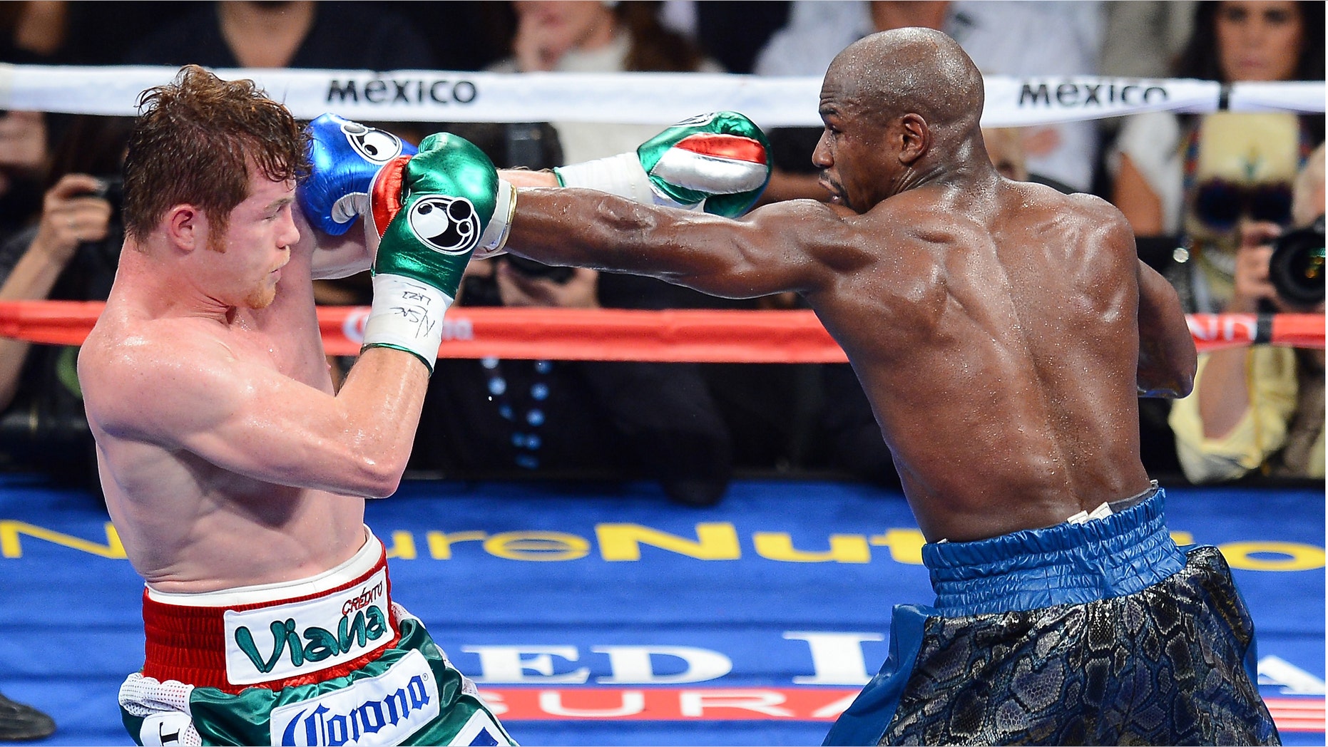 Floyd Mayweather Jr. throws a left at Canelo Alvarez at the MGM Grand Garden Arena on September 14, 2013 in Las Vegas, Nevada.