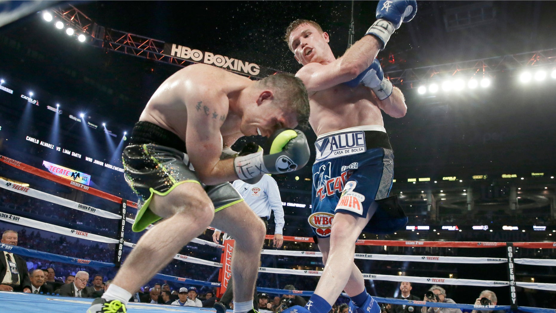 Canelo Alvarez punches Liam Smith during the eight round of the WBO Junior Middleweight championship boxing match at the stadium in Arlington, Texas, Saturday, Sept. 17, 2016. Alvarez won with a knock out in the ninth round. (AP Photo/LM Otero)