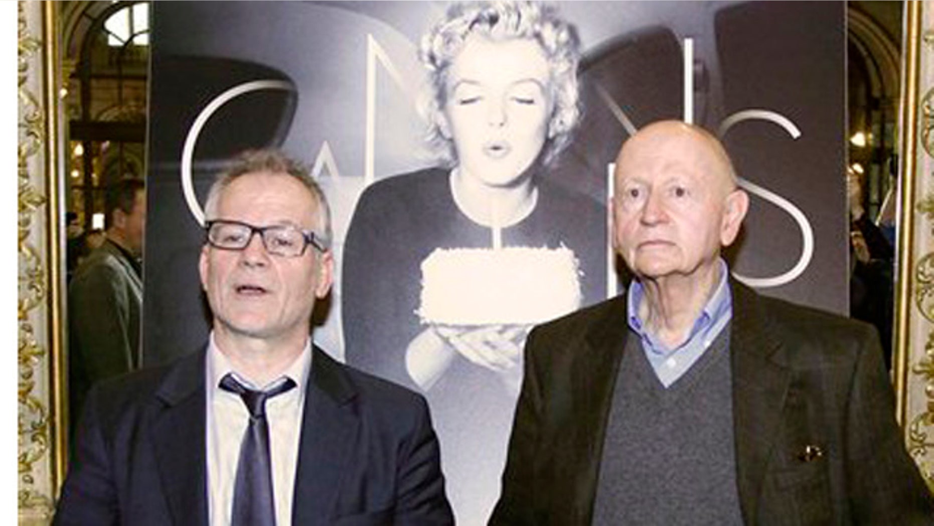 April 19, 2012: President of the Cannes Film Festival Gilles Jacob, left, and artistic Director Thierry Fremaux, pose in front of the Cannes International Film Festival poster for the upcoming 65th edition of the festival featuring US actress Marilyn Monroe during a press conference to announce this years festival line up in Paris.