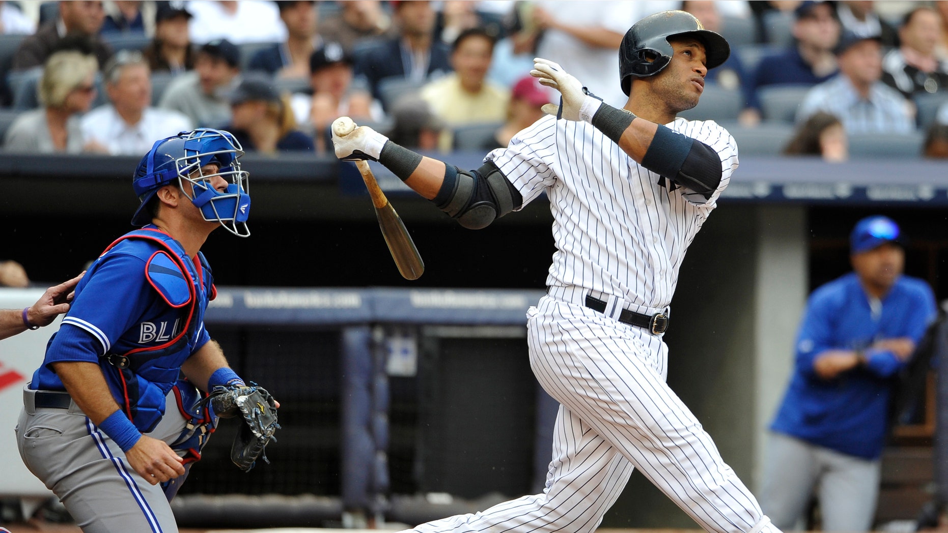 FILE - In this May 18, 2013 file photo, Toronto Blue Jays catcher J.P. Arencibia and New York Yankees Robinson Cano watch Cano's two-run home run off of starting pitcher Brandon Morrow in the fifth inning of a baseball game at Yankee Stadium in New York. On the first deadline day of the offseason, teams had until 5 p.m. to make $14.1 million qualifying offers to their eligible free agents, a group that includes Cano, Jacoby Ellsbury, Carlos Beltran and Shin-Soo Choo. (AP Photo/Kathy Kmonicek, File)