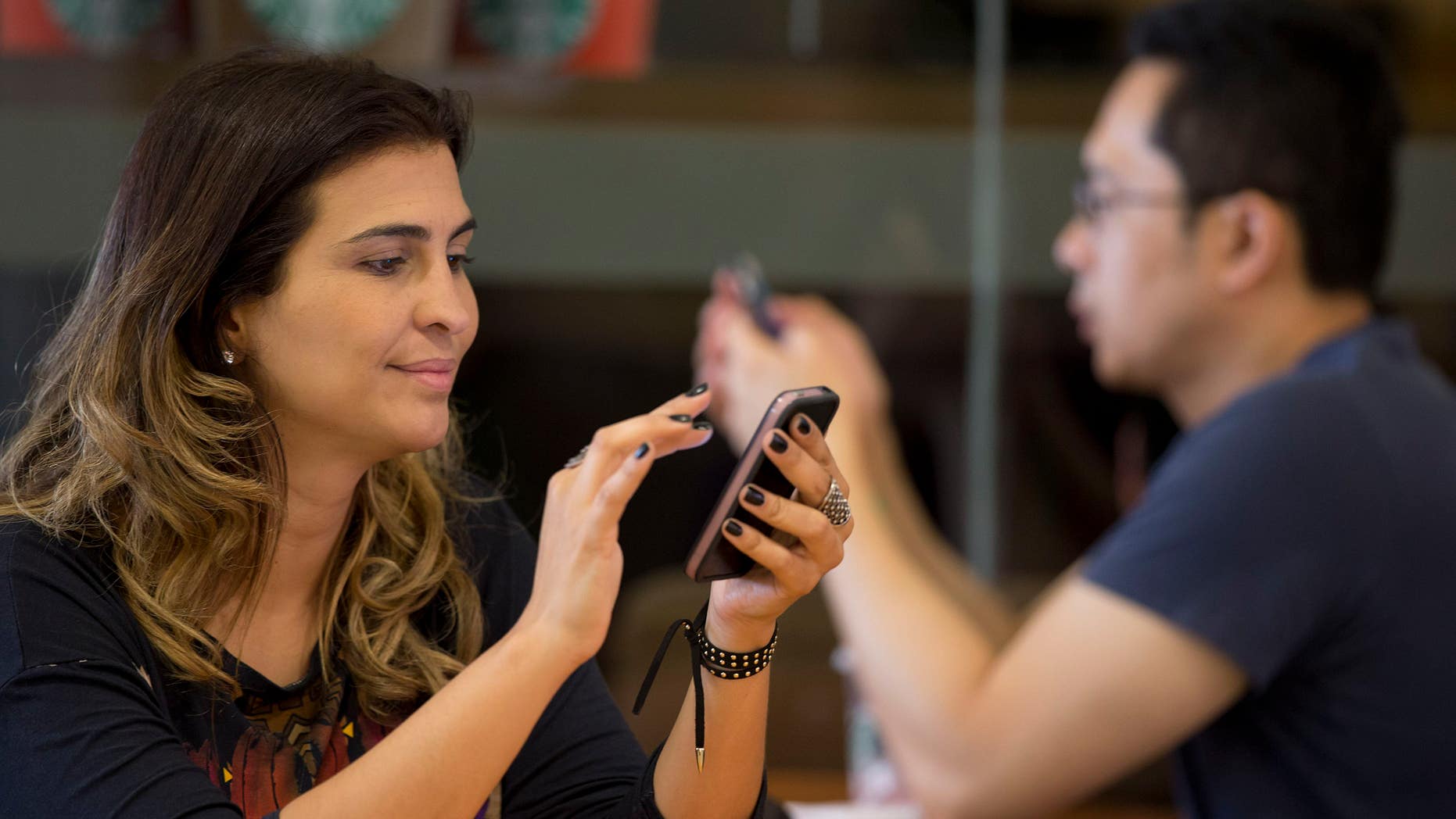 A woman checks her cell phone in Brazil.