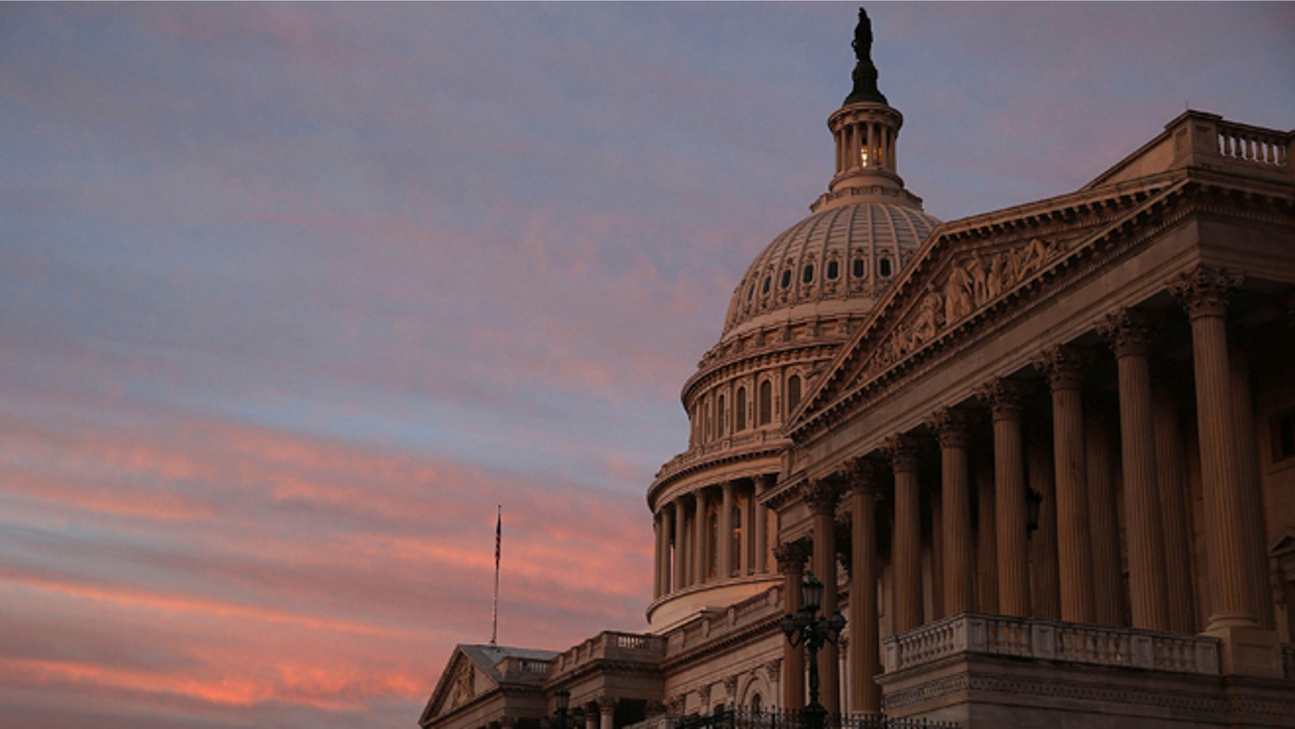 WASHINGTON, DC - SEPTEMBER 25: The sky changes color over the U.S. Capitol as the sun begins to rise September 25, 2013 in Washington, DC. Later today the U.S. Senate will vote on a stopgap spending bill that that passed the House last week. (Photo by Mark Wilson/Getty Images)