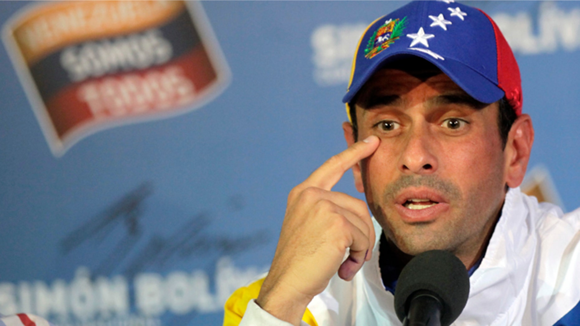 Opposition presidential candidate Henrique Capriles talks to journalists during a press conference at his campaign headquarters in Caracas, Venezuela, Tuesday, April 16, 2013. (AP Photo/Ramon Espinosa)