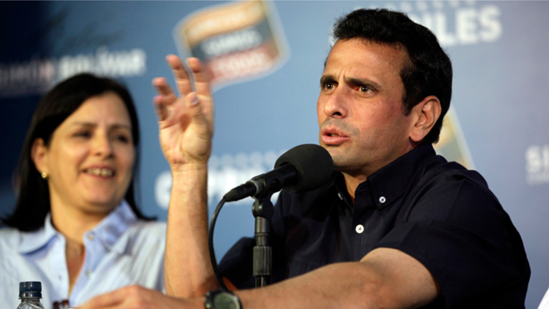 Opposition leader Henrique Capriles gestures during a press conference in Caracas, Venezuela, late Thursday, April 18, 2013. Venezuela's electoral council said Thursday it would audit the 46 percent vote that was not scrutinized election night. Capriles had demanded a full vote-by-vote recount, and has maintained that Sunday's election, which the National Electoral Council had declared won by Hugo Chavez's heir Nicolas Maduro by 262,00000 votes out of 14.9 million cast, was stolen from him through intimidation and other abuses.(AP Photo/Ariana Cubillos)