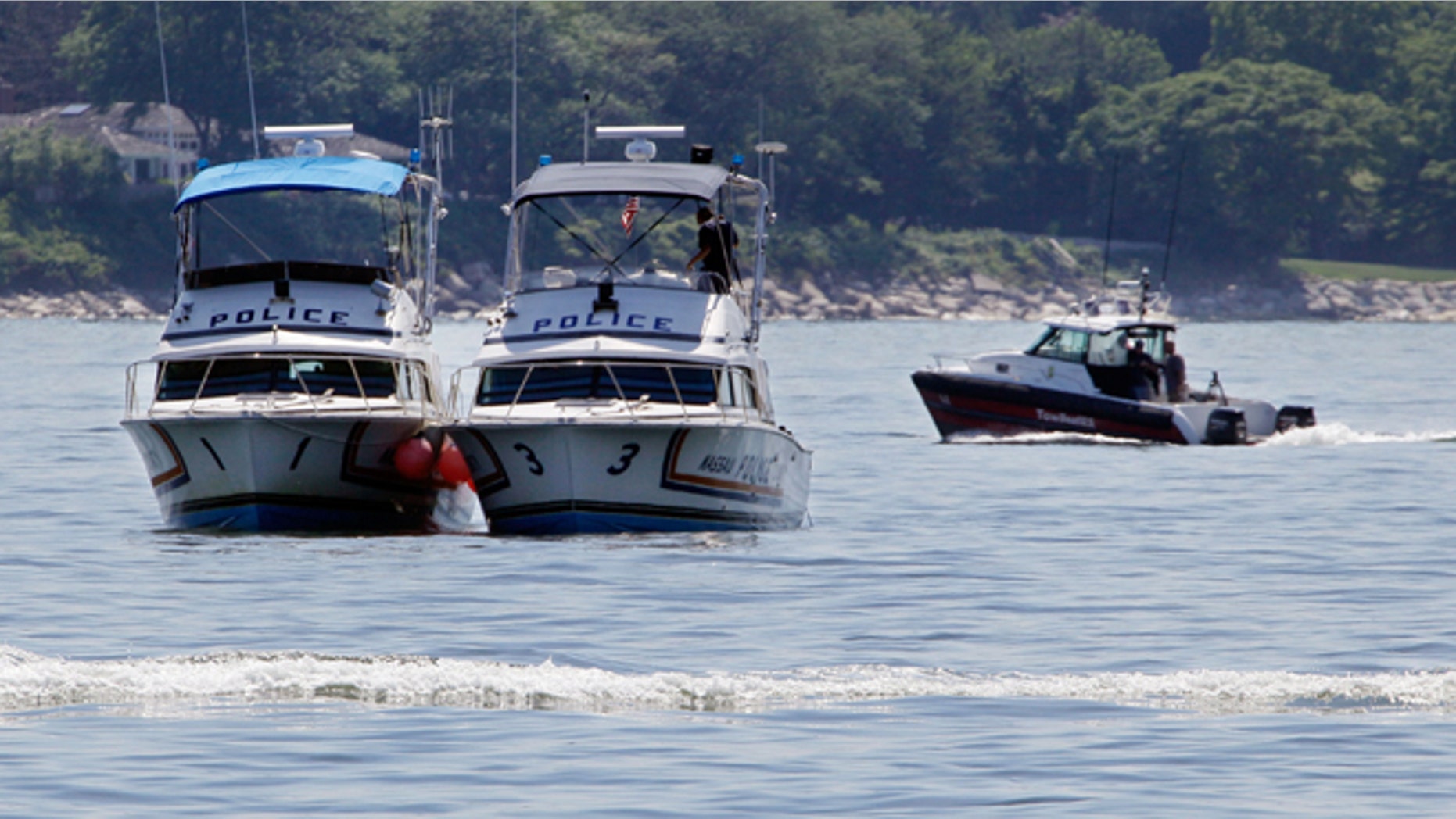 July 6: Two Nassau County police boats are stationed near the opening to the Long Island Sound in Lloyd Harbor, N.Y.