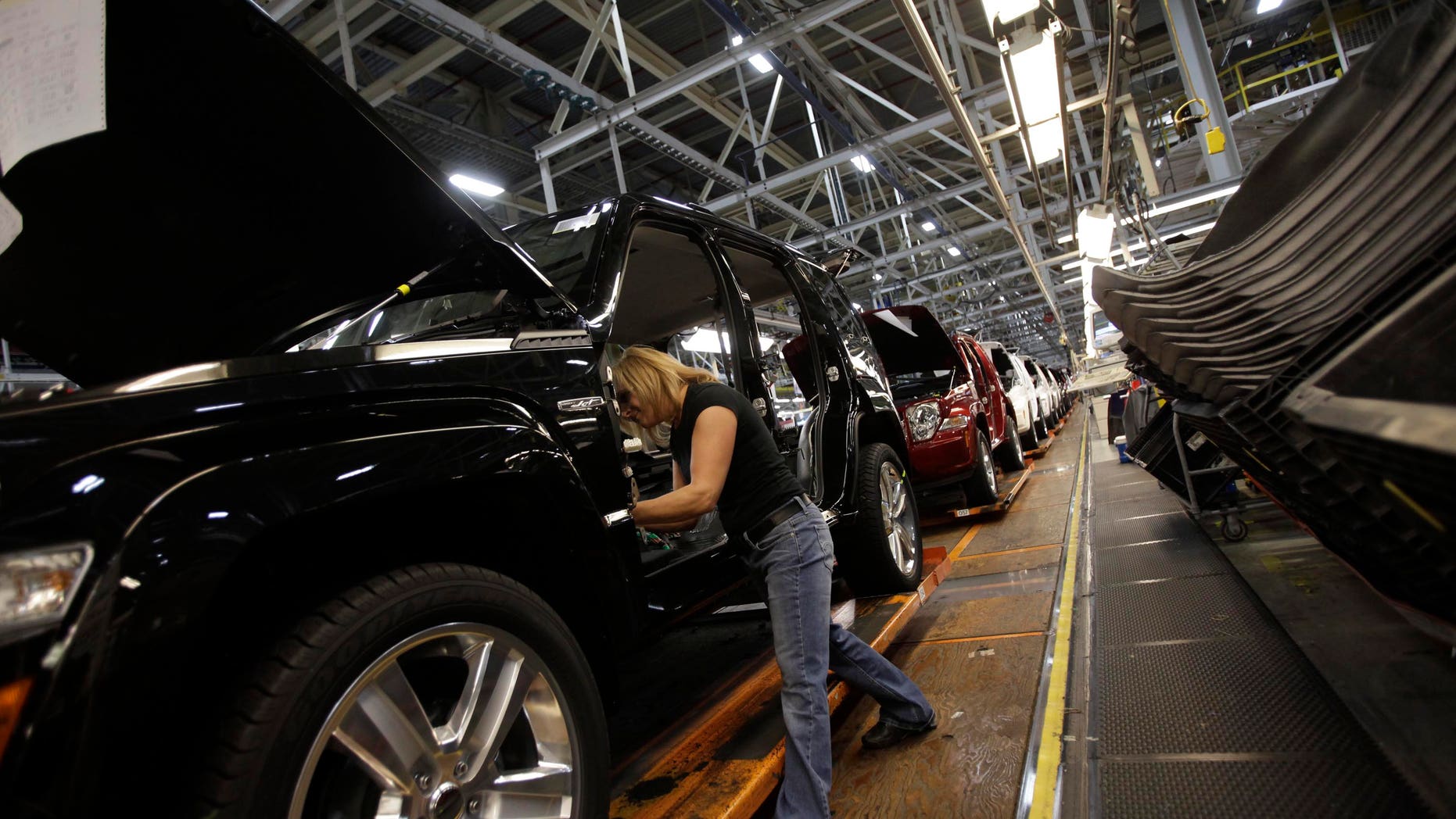 TOLEDO, OH - NOVEMBER 16: Union worker Pam Bialecki installs carpet into a Jeep Liberty at the Toledo Assembly Complex on November 16, 2011 in Toledo, Ohio. Chrysler Group LLC says it will add 1,100 jobs at the Toledo, Ohio assembly complex along with a new body shop and quality center as part of an overall $1.7 billion investment to build a new generation of Jeep sport utility vehicles. (Photo by J.D. Pooley/Getty Images)
