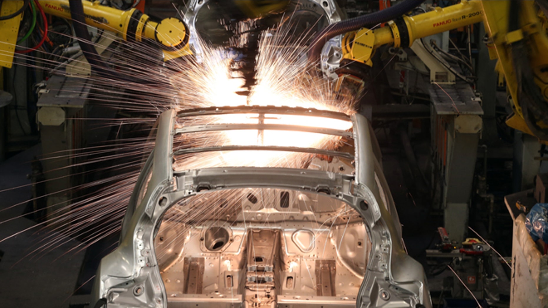 Robotic arms assemble and weld the body shell of a Nissan car on the production line. (Photo by Christopher Furlong/Getty Images)