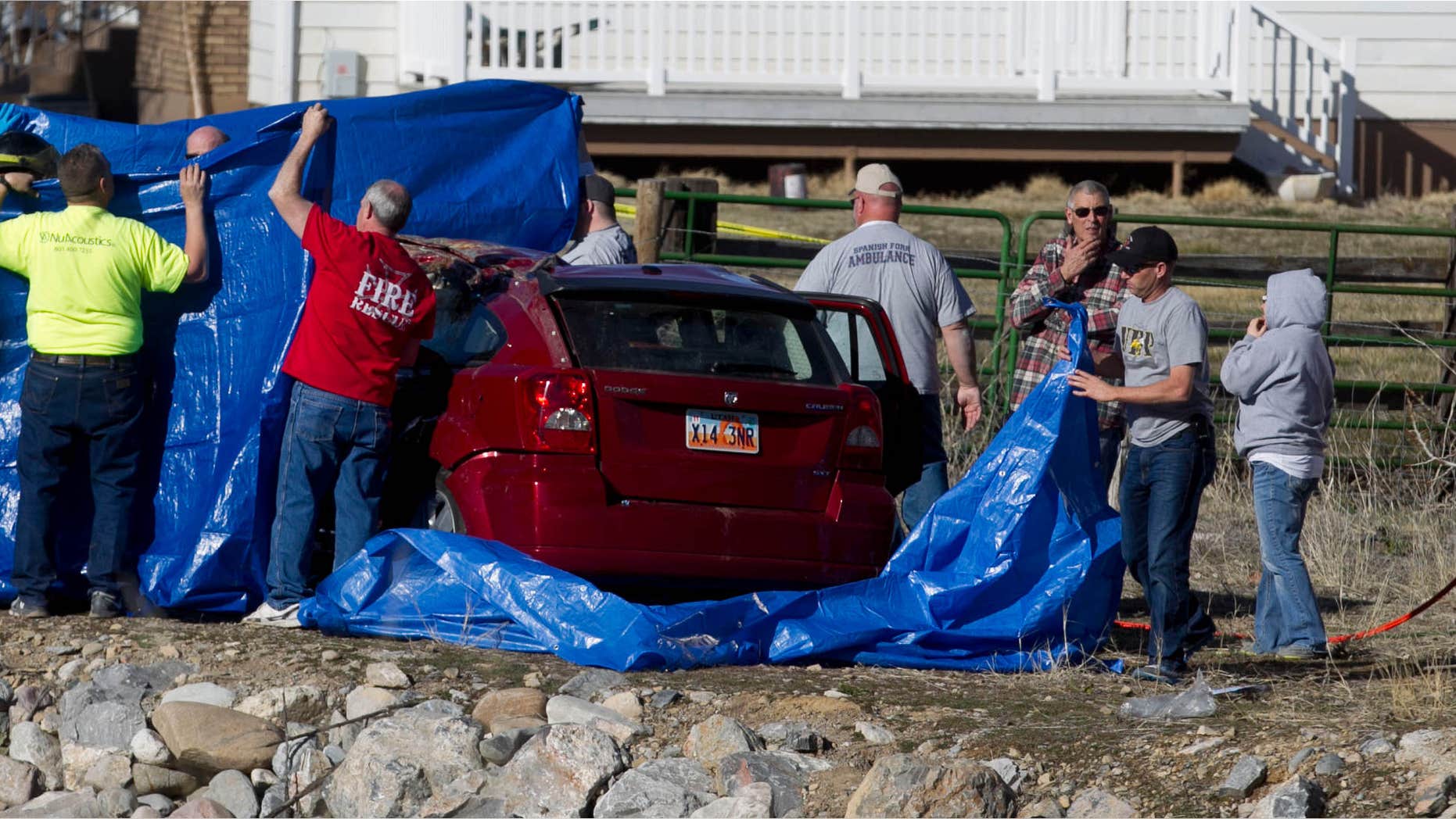 March 7, 2015: Officials respond to a report of car in the Spanish Fork River near the Main Street and the Arrowhead Trail Road junction in Spanish Fork, Utah.