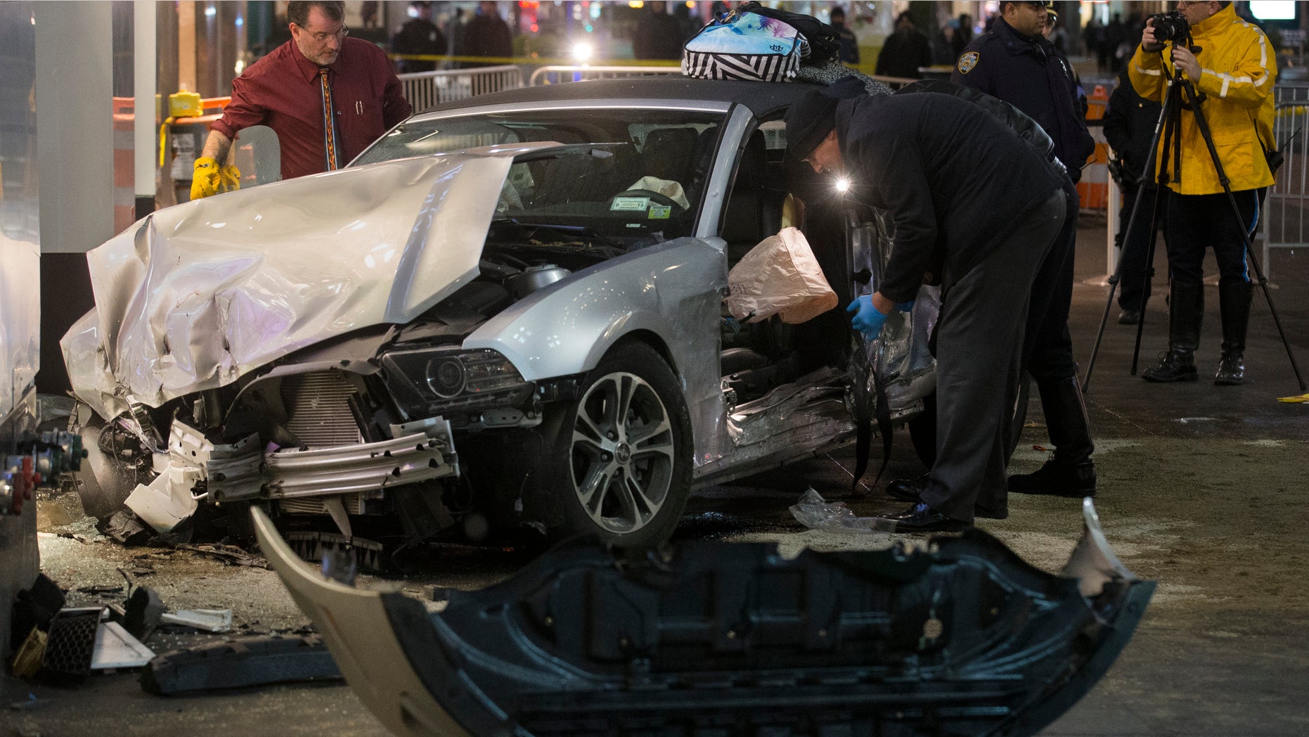 Dec. 11, 2014: Police search a car at the scene of a vehicular accident on 34th Street.